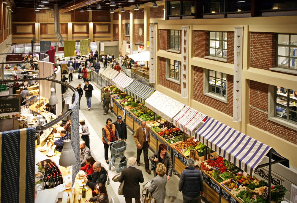 Eataly marketplace interior showing bustling fresh produce market with traditional Italian aesthetic, multiple food stations, and immersive retail experience demonstrating brand's authentic Italian food culture positioning - omnichannel customer journey integration across 20+ cities in 3 continents coordinated by Alessandro Brancati Marketing & Growth Studio