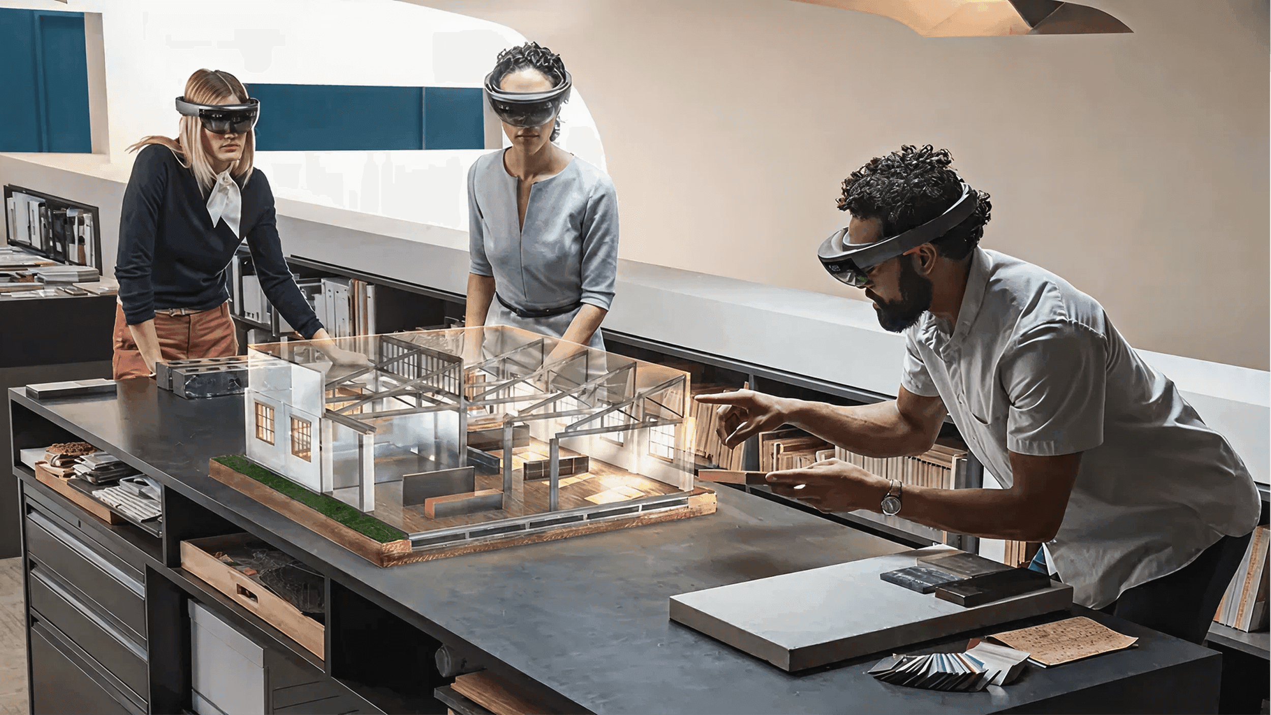 Architects reviewing a holographic building model anchored to a physical table using MR headsets.