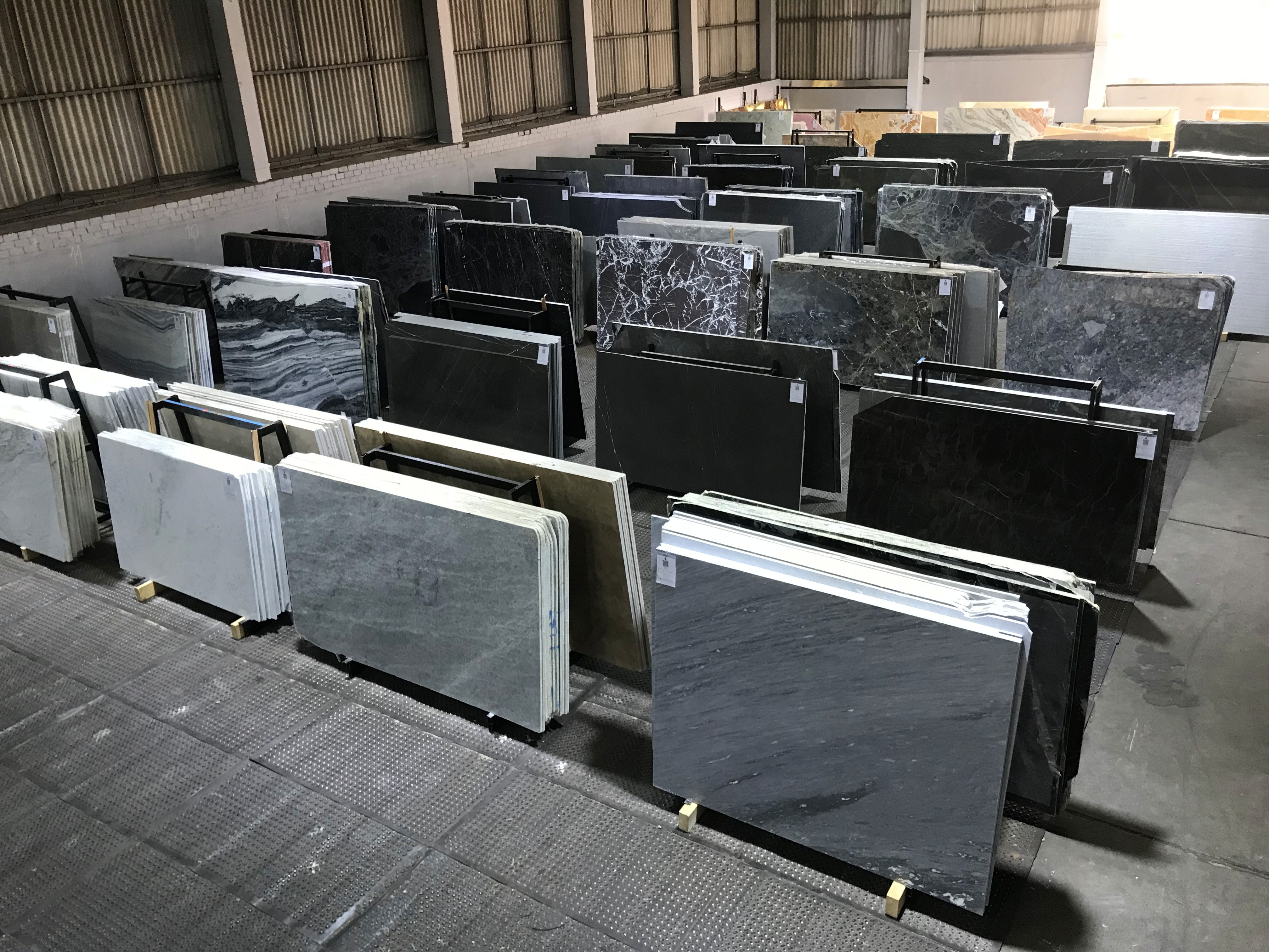 Selection of natural stone slabs in the warehouse for kitchen worktops.