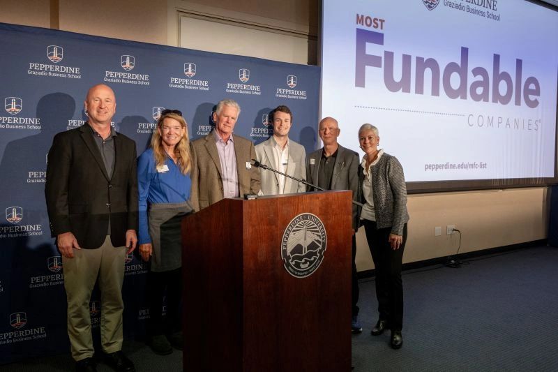 a black and white living room with a large tv