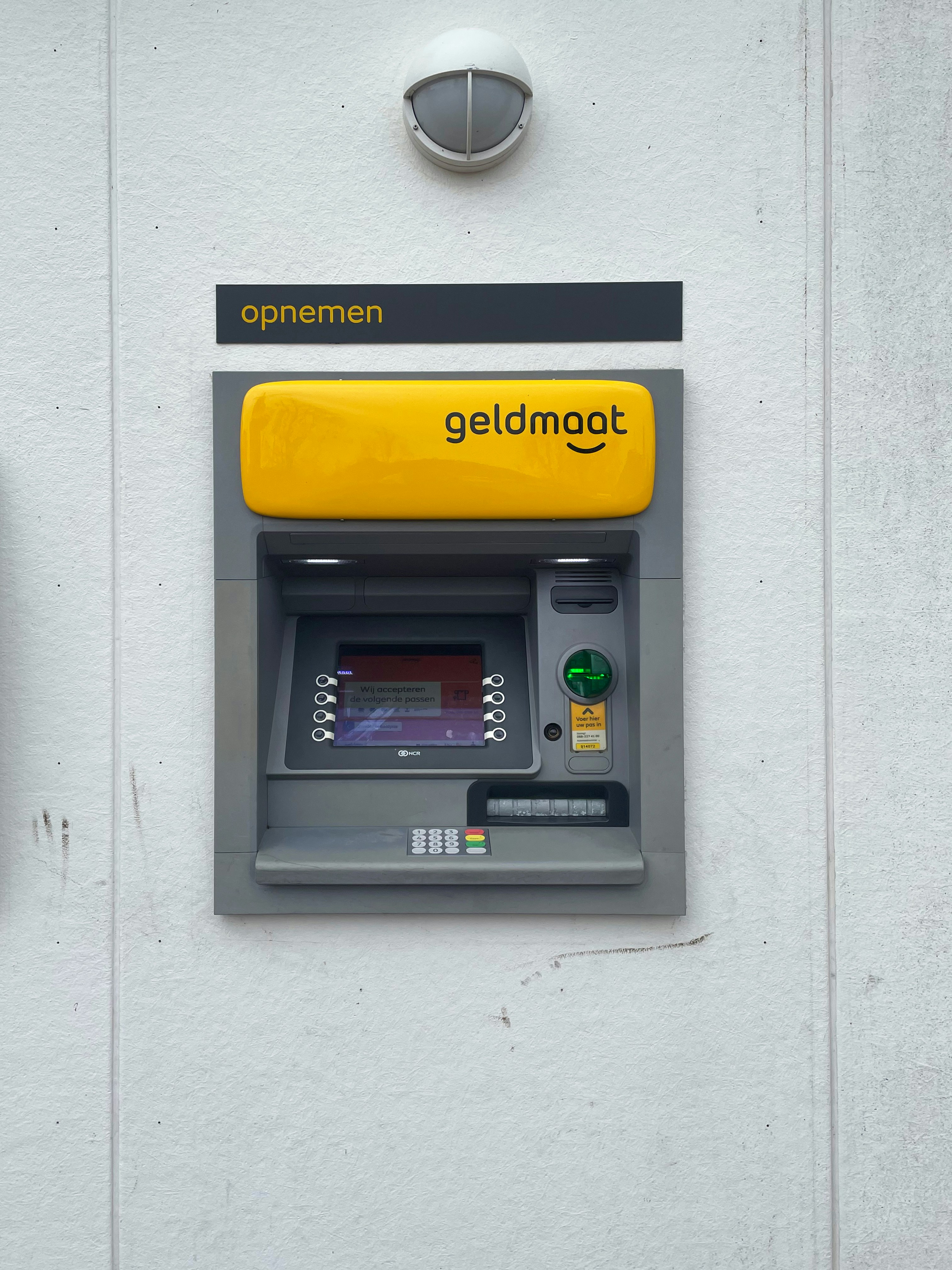 a close up of a payphone on a wall