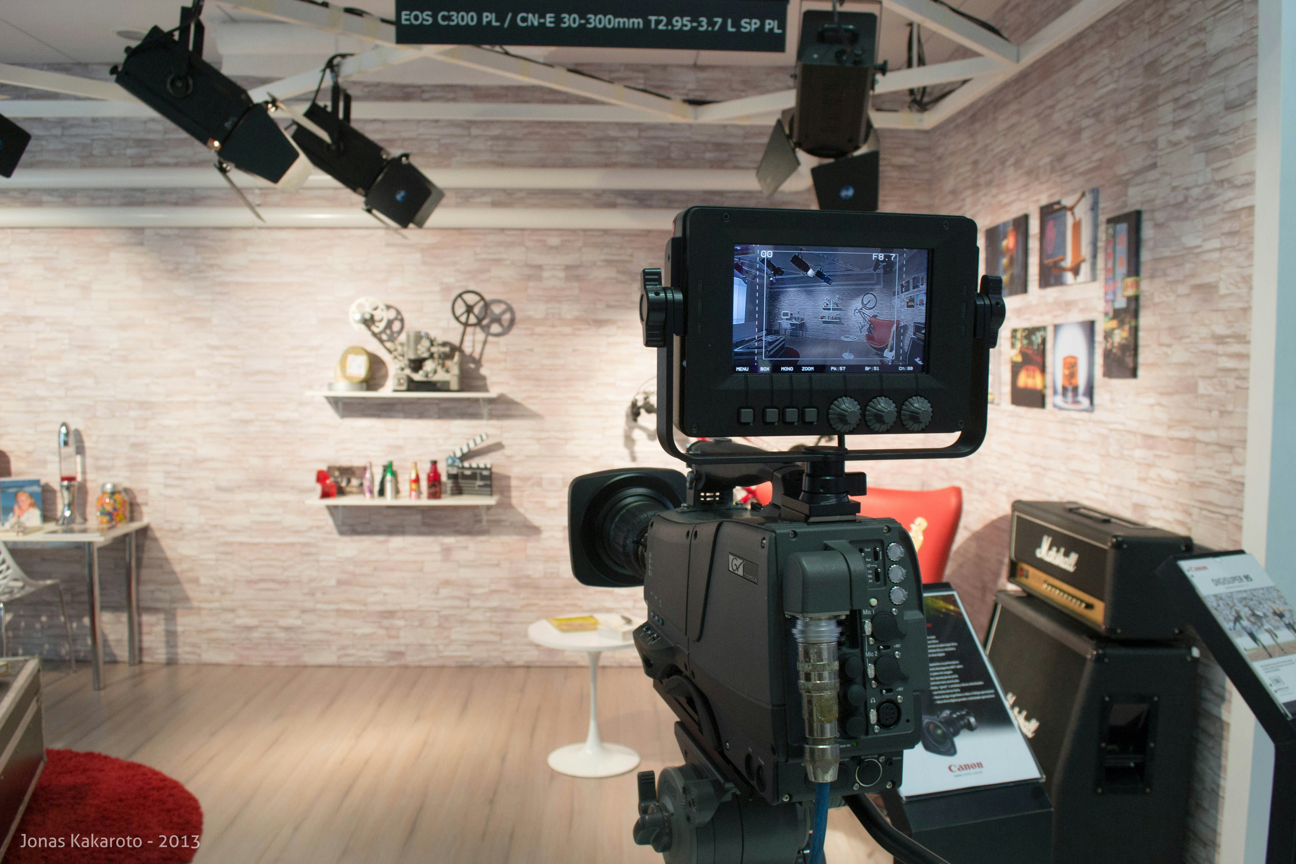 A camera set up in front of a television in a room