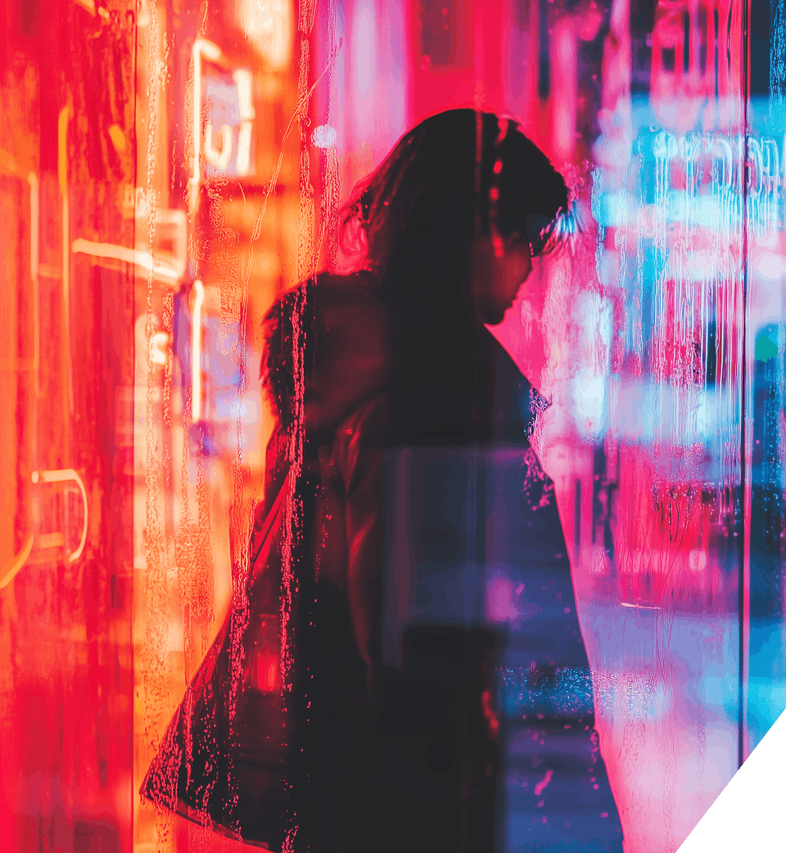 A figure poses in front of a glowing neon sign, casting colorful light on their surroundings.