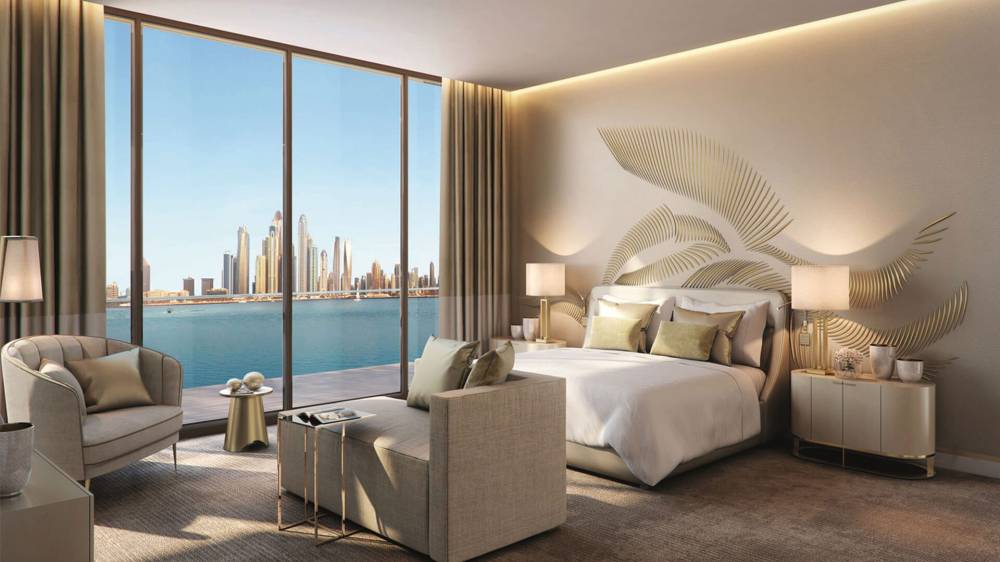 A stylish bedroom at The Royal Atlantis, complete with a large bed and a modern television for relaxation.