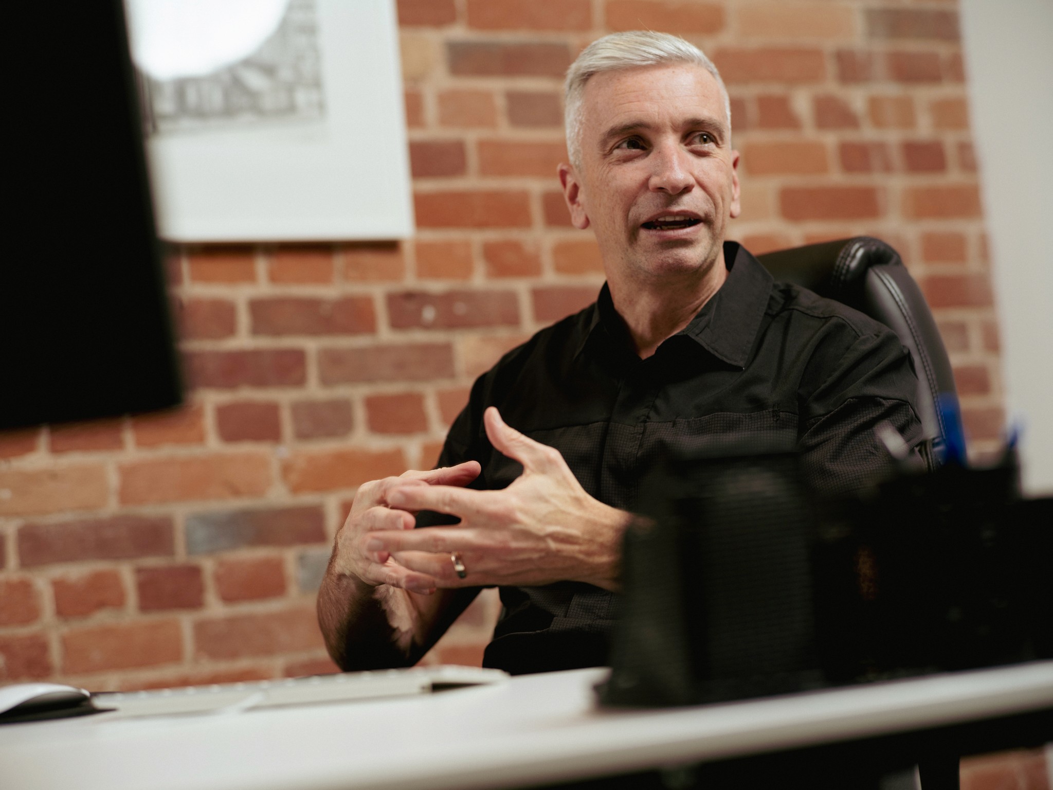 Trevor Trewartha, CEO & Strategic Director of 1dea talks at his desk