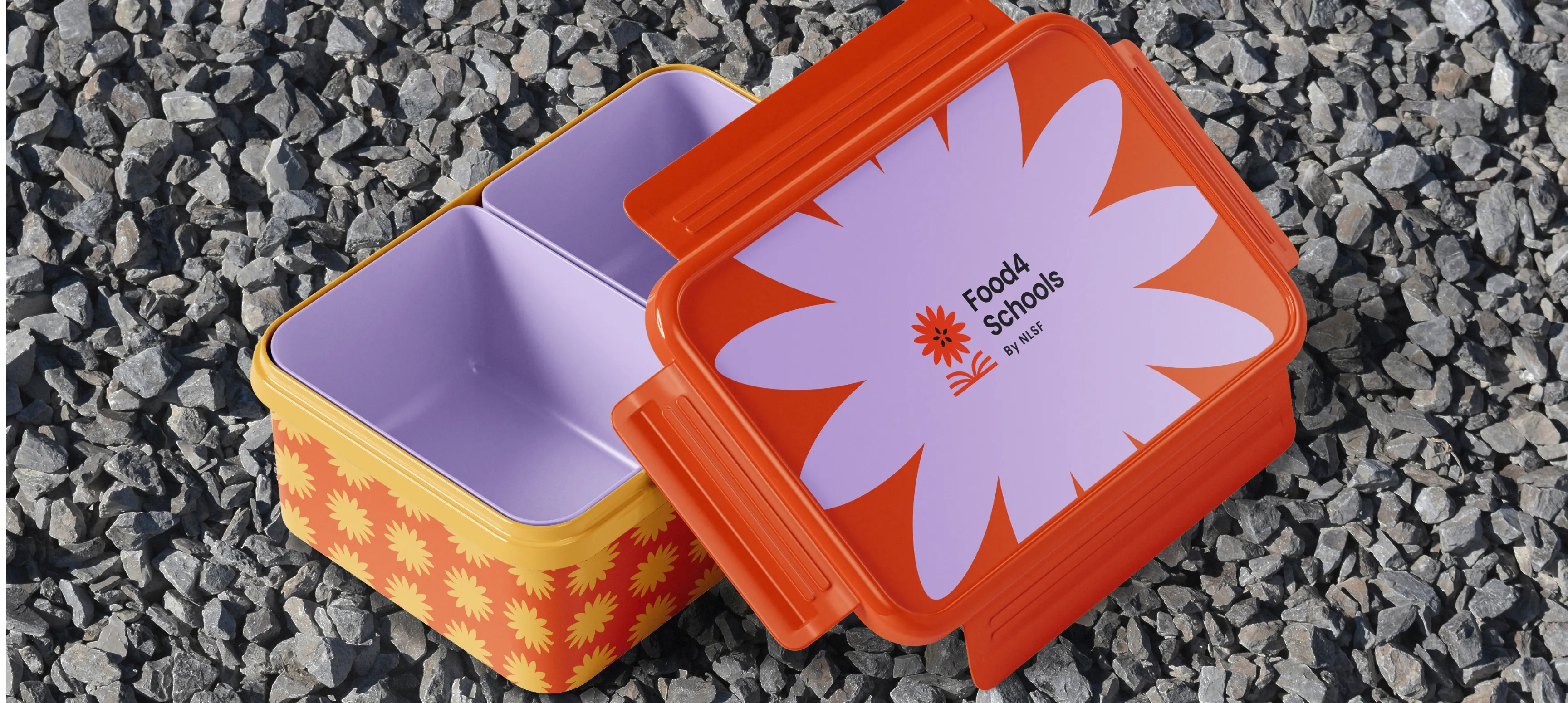 A Food4Schools branded lunch kit sitting on gravel.