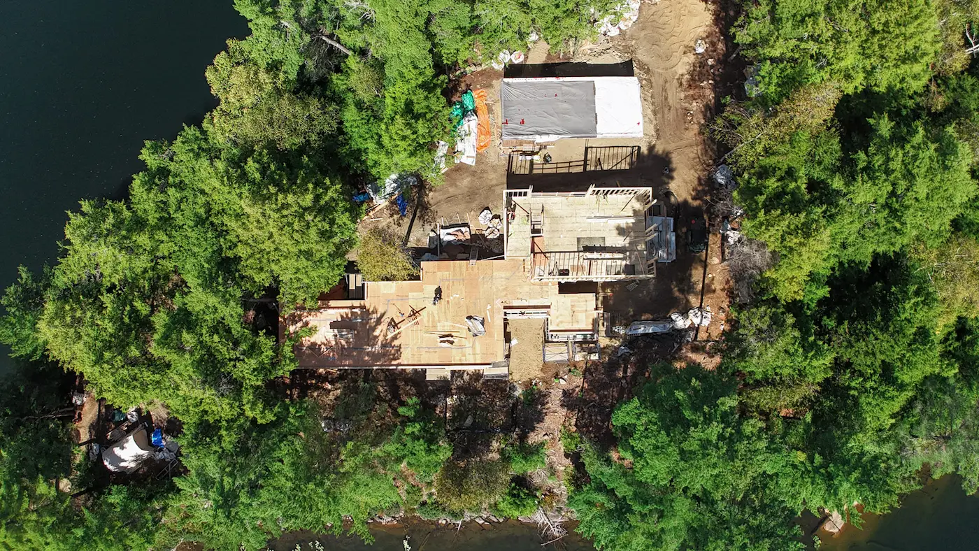 rockaway lake secluded island cabin in construction surrounded by trees.