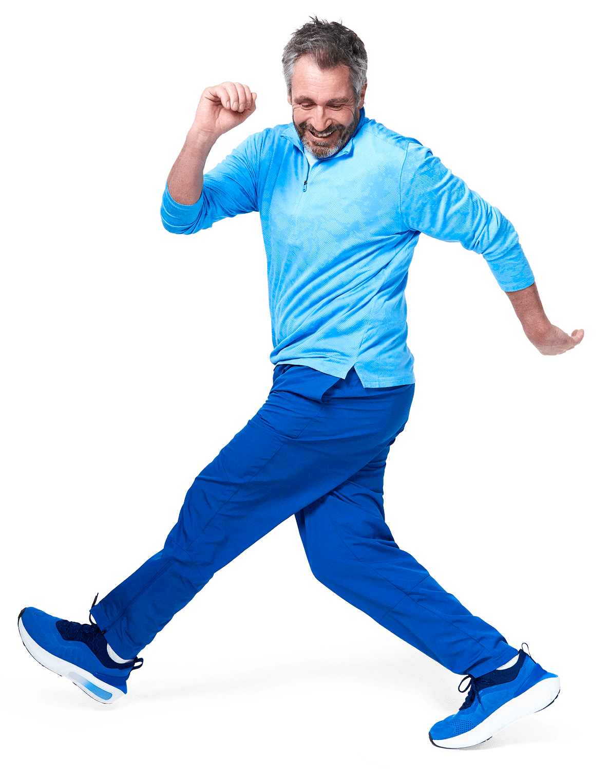 A joyful man in a blue outfit energetically walks with a cheerful expression, capturing a sense of movement.