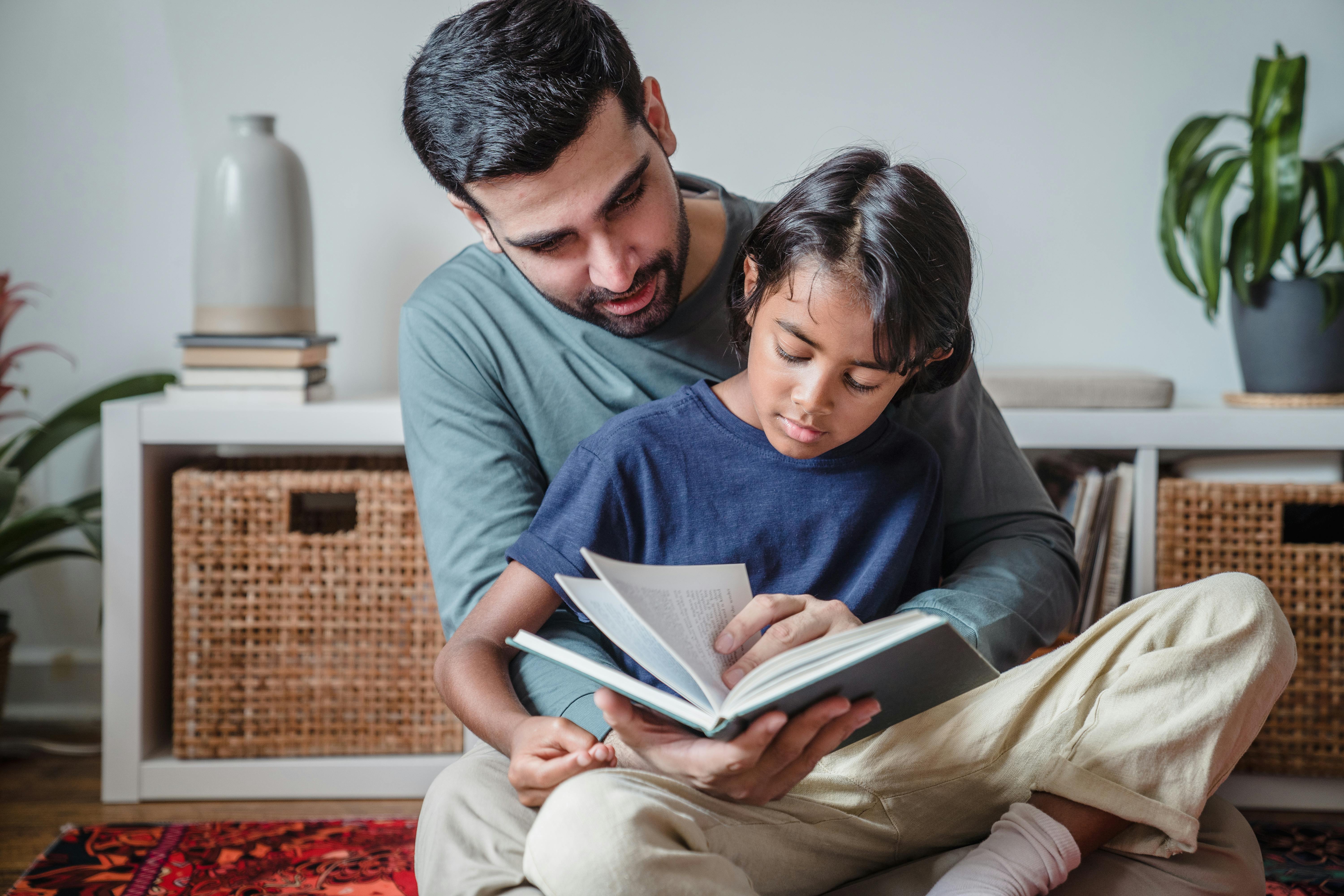 Father and son reading a book