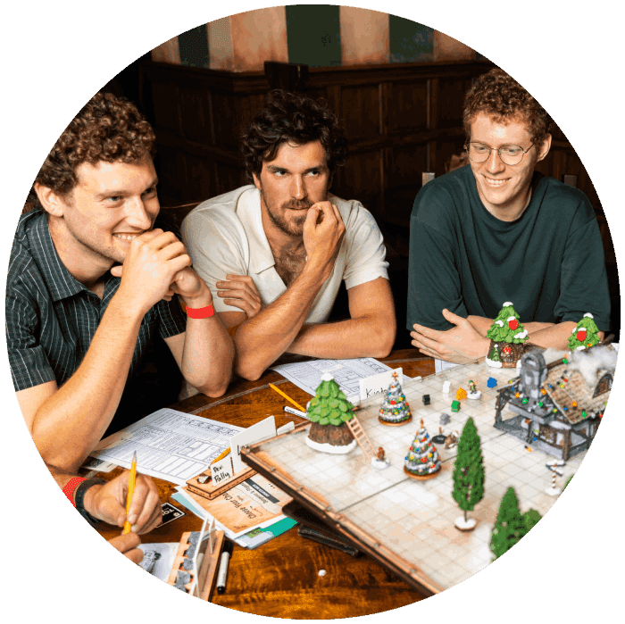 Three friends sitting in the Fortress Tavern playing tabletop games