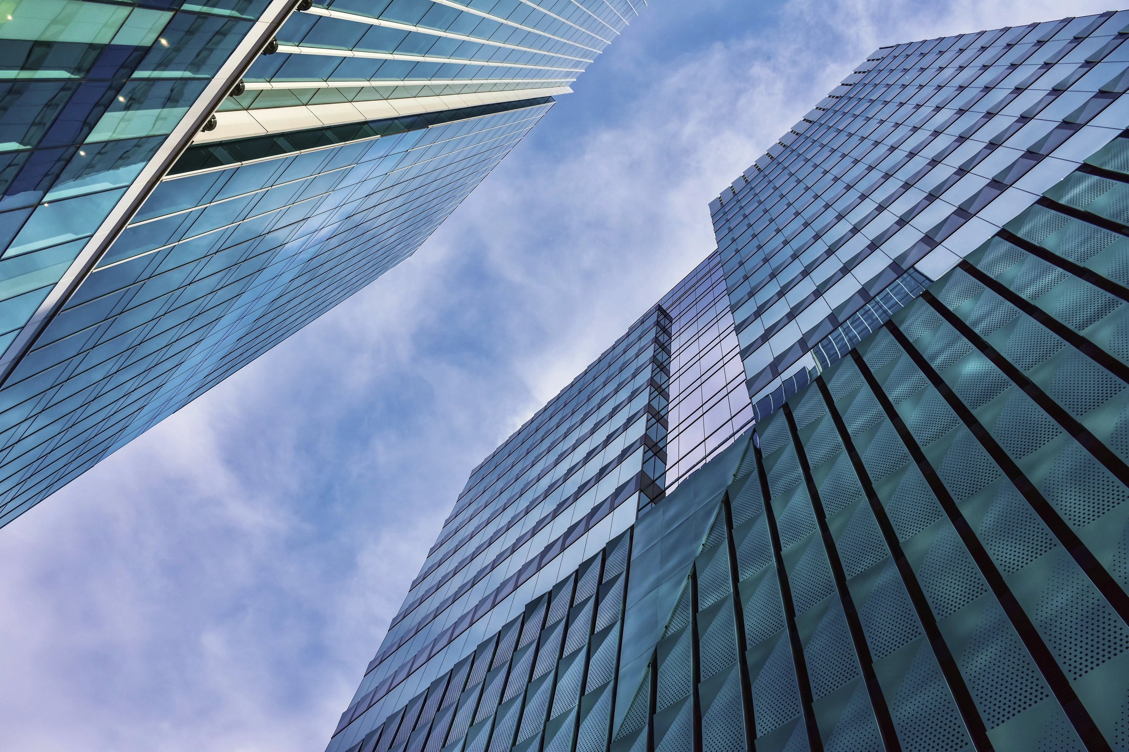 A low-angle photograph of buildings in a large city.