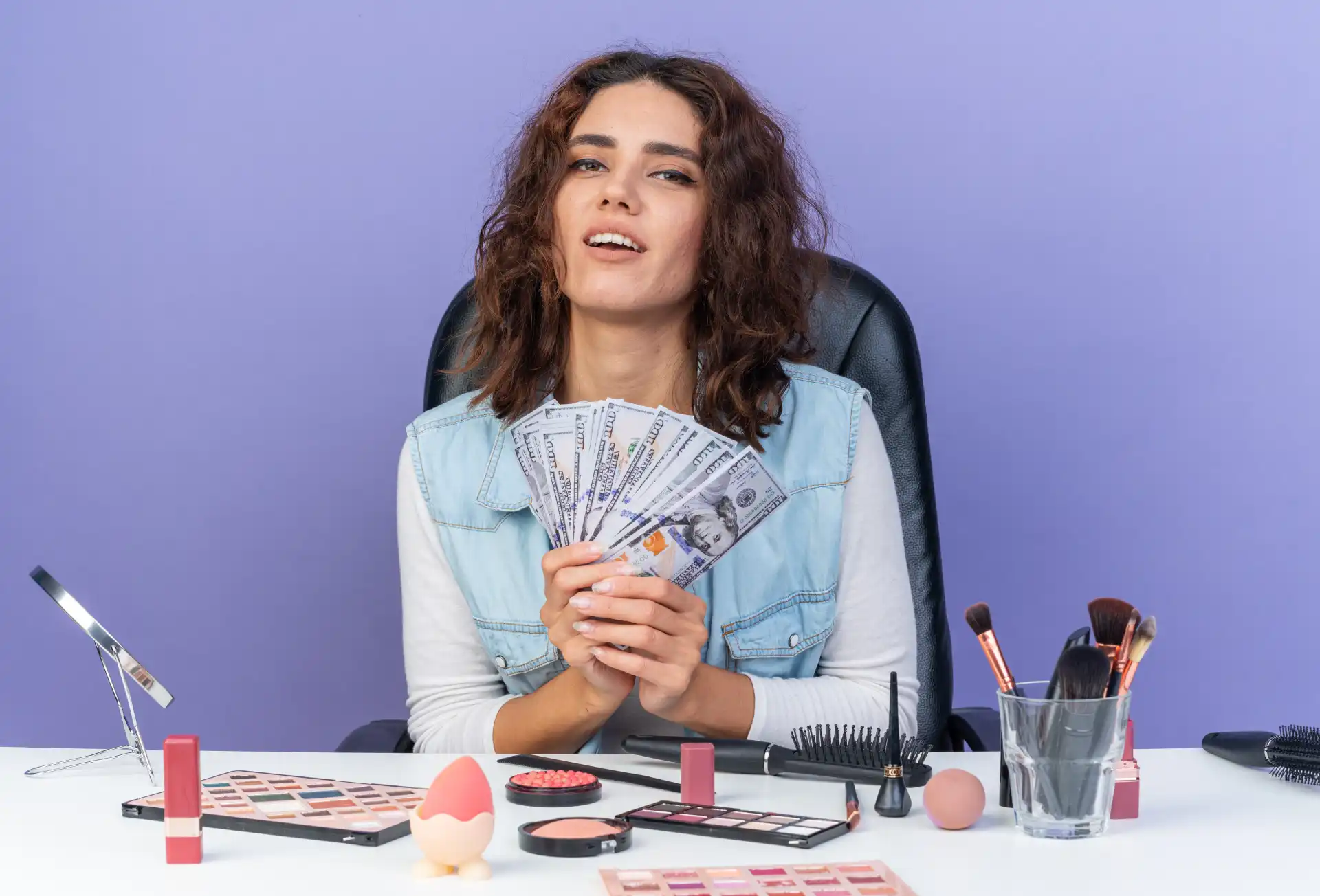 Content creator holding commission earnings from TikTok Shop affiliate sales surrounded by product setup and ring light
