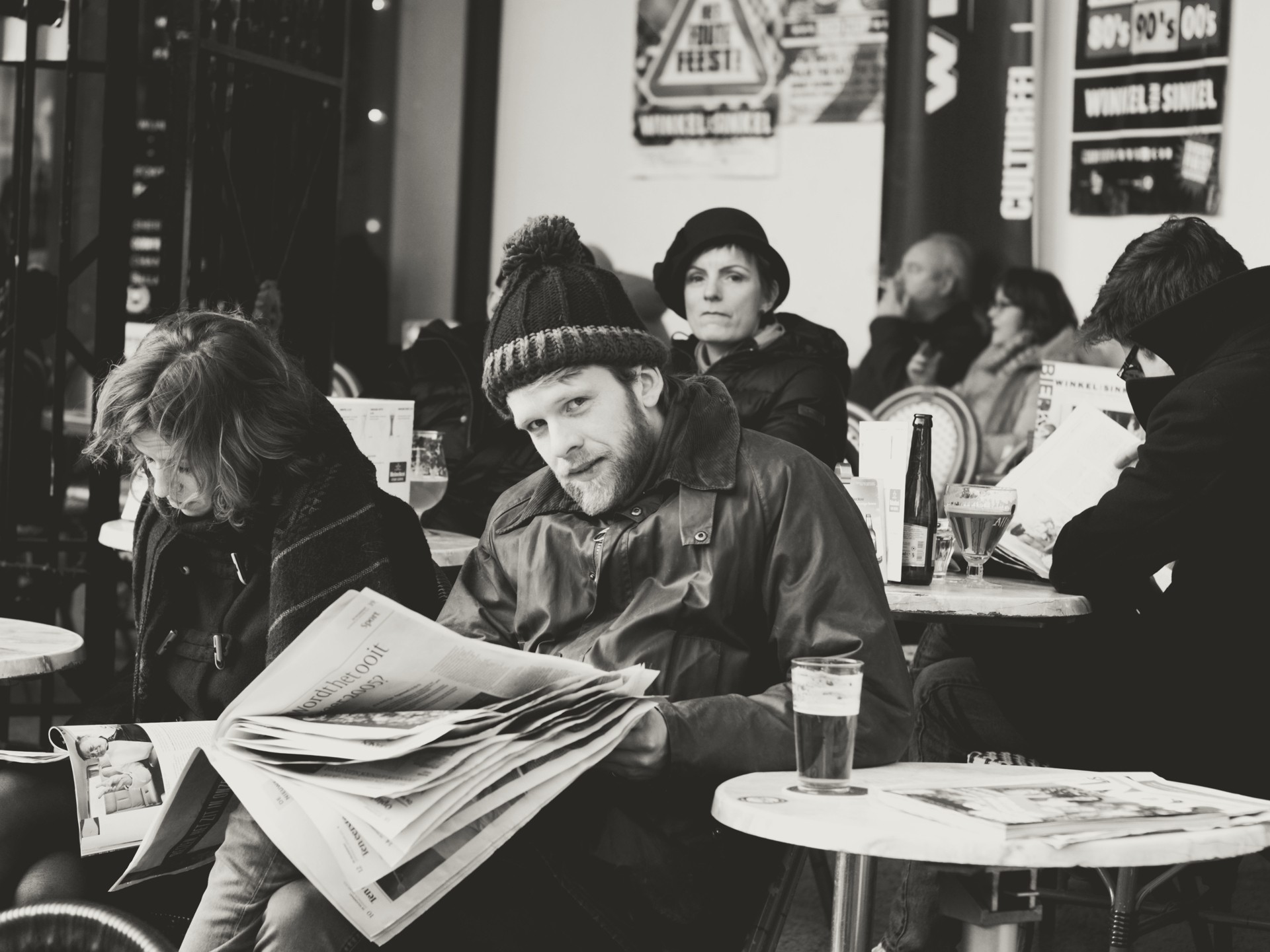 Photo of a man reading a newspaper on a terrace