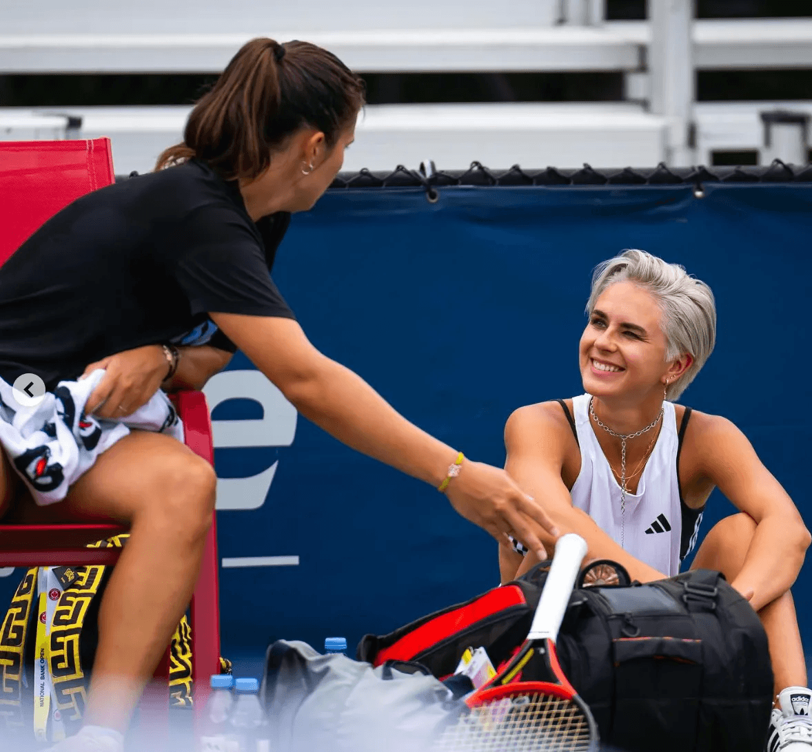 Russian tennis player and videographer, Daria Kasatkina, continues practice while partner Natalia Zabiiako looks on.
