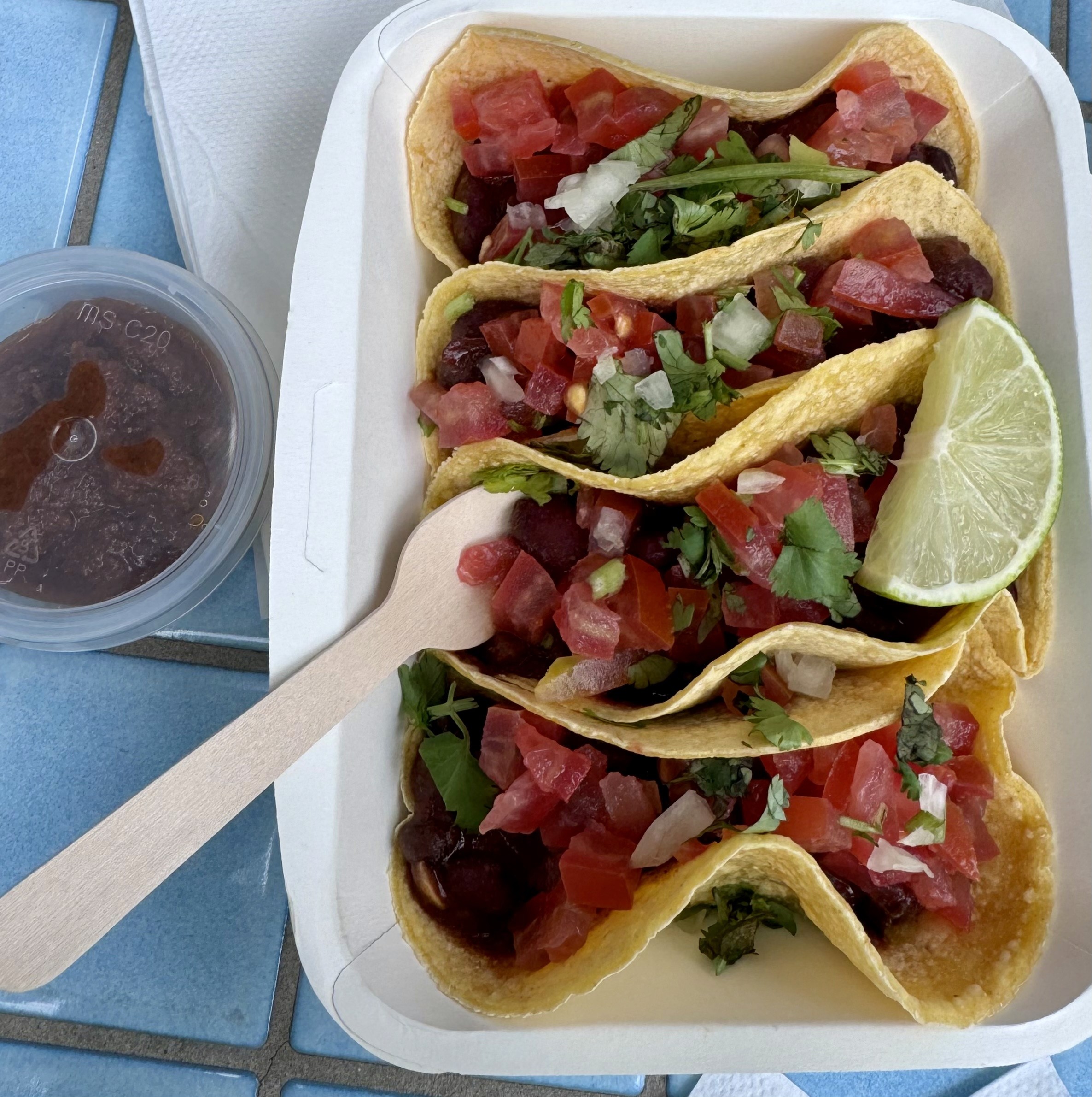 Veggie tacos served with salsa in a takeaway box