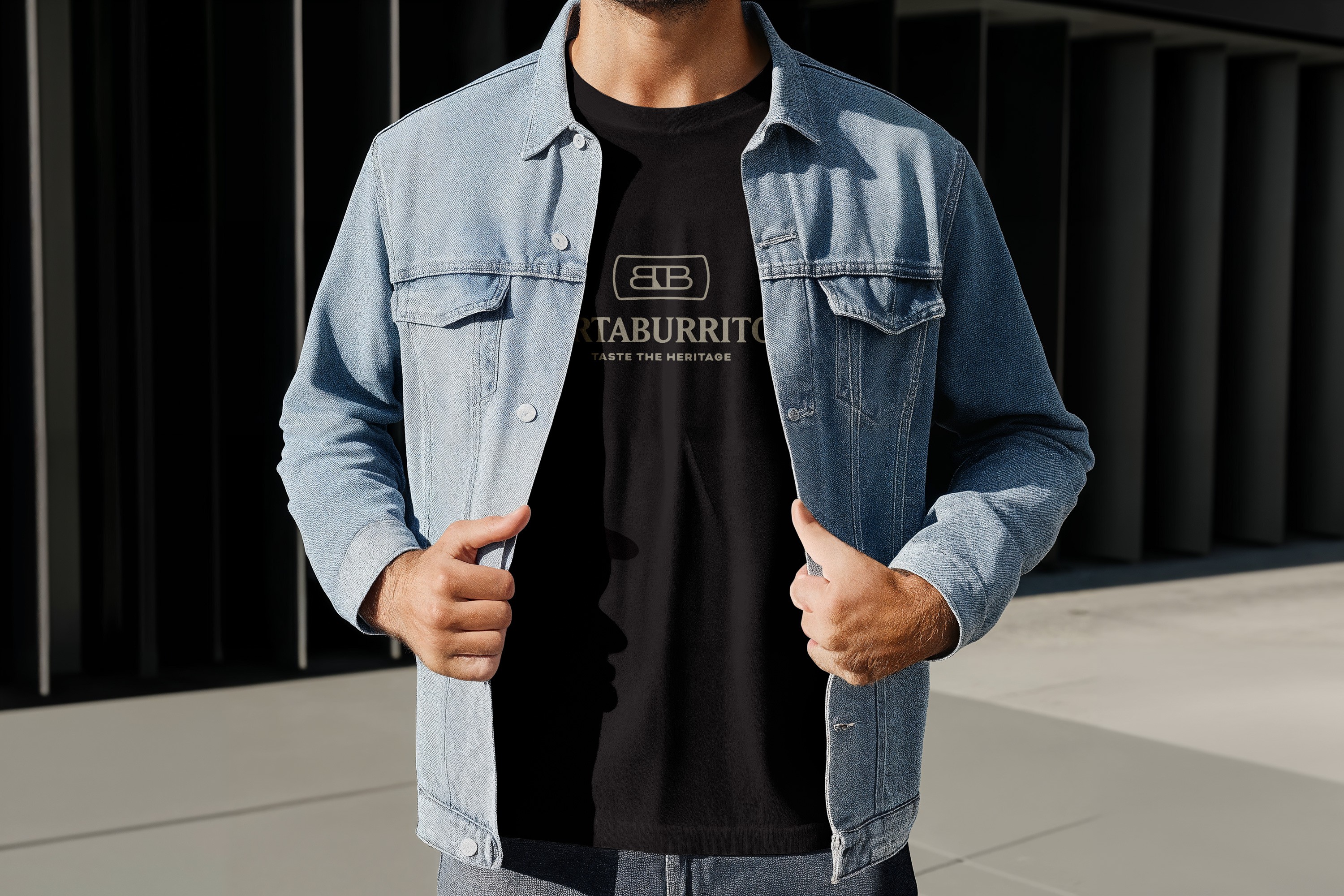 A man wearing a denim jacket, revealing a logo for a mexican restaurant