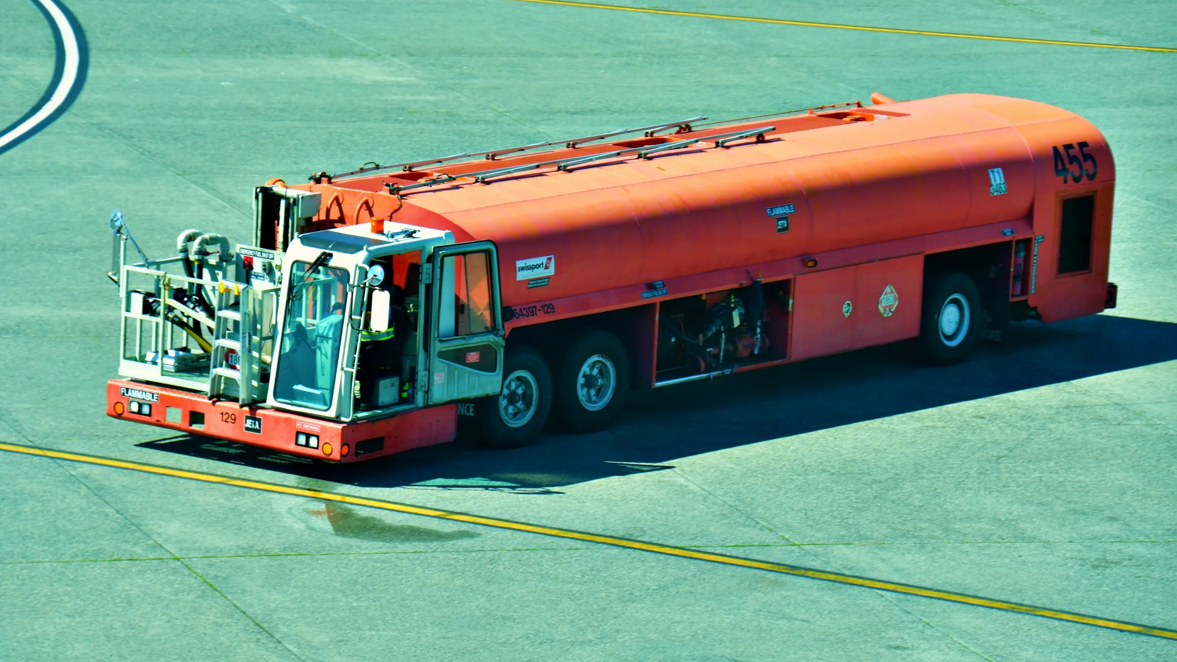 An aircraft refueling truck crossing the airport apron