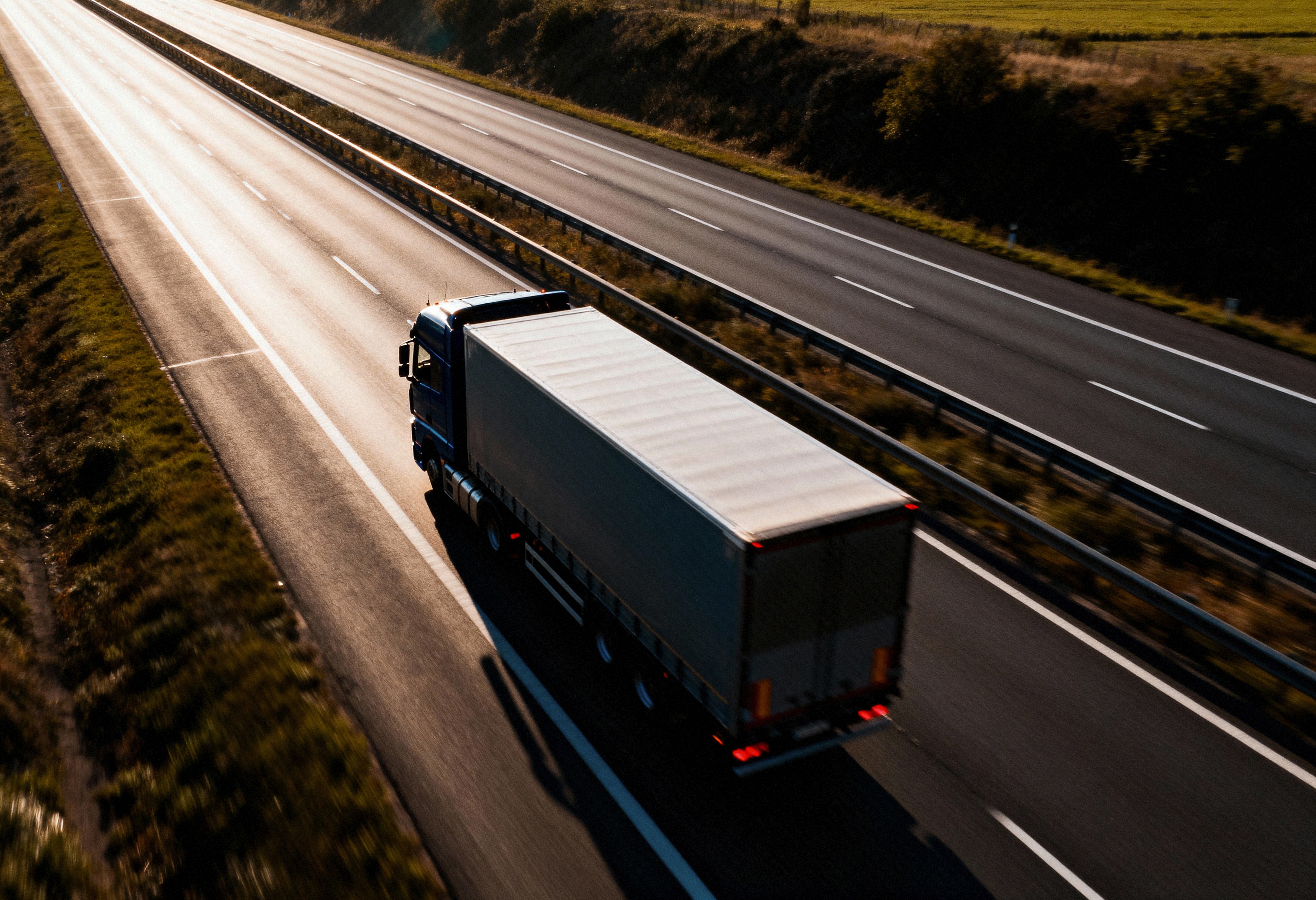 Convoy of Light Blue Volvo Trucks on Highway