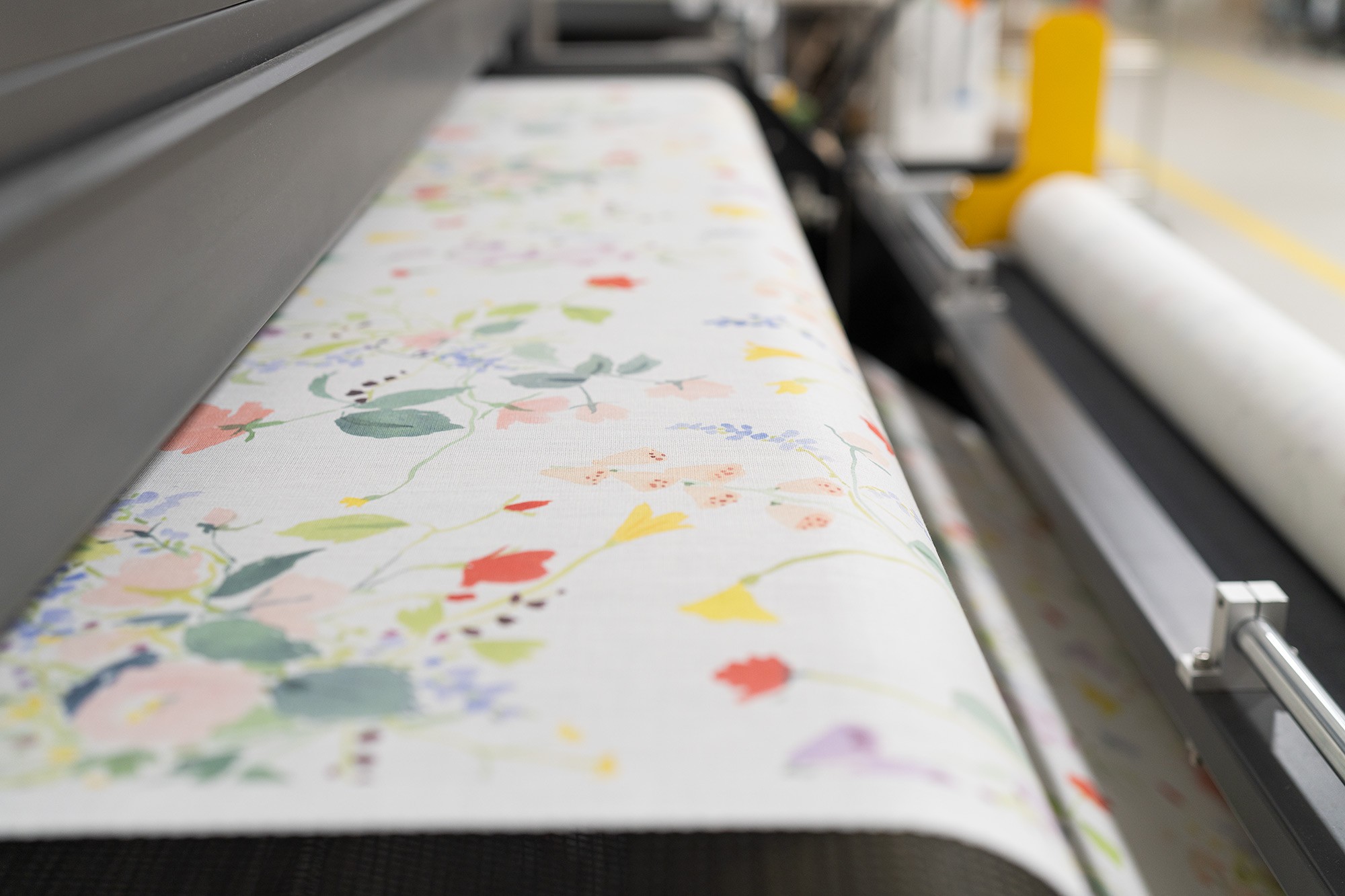 Floral pattern textiles being printed.
