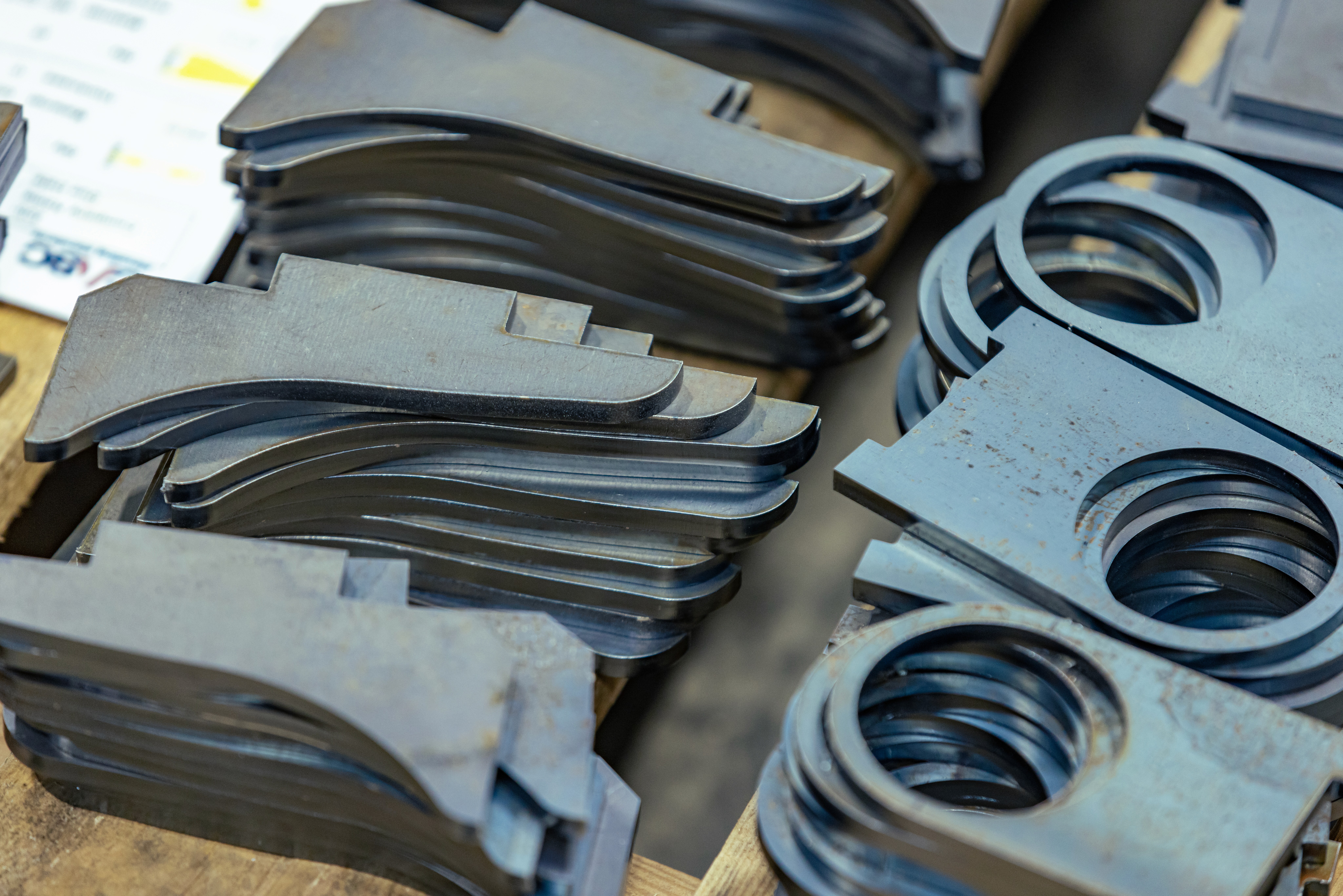 A CASC employee supervising the delivery of steel frame components on a flatbed lorry.