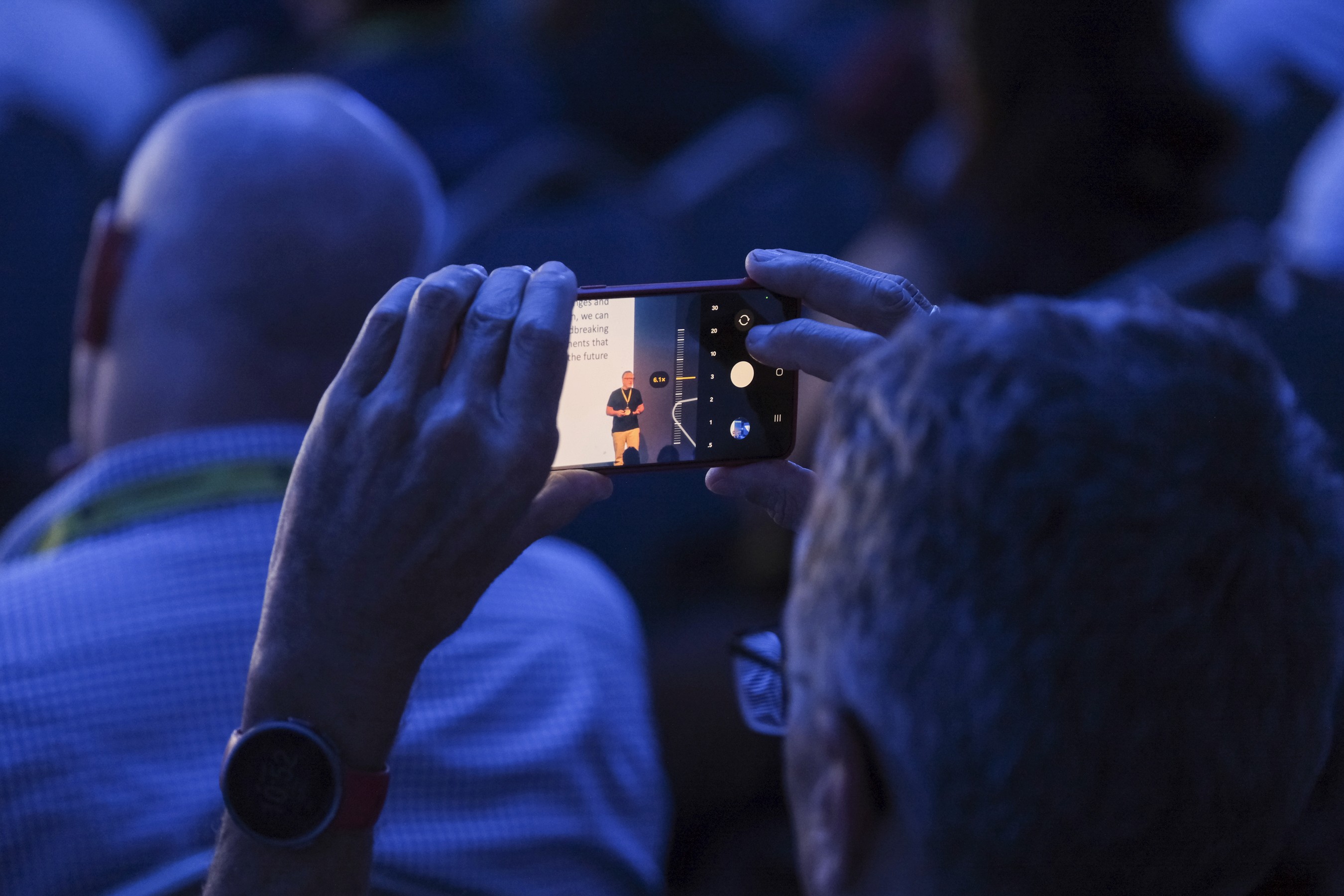 A conference event attendee taking a photo