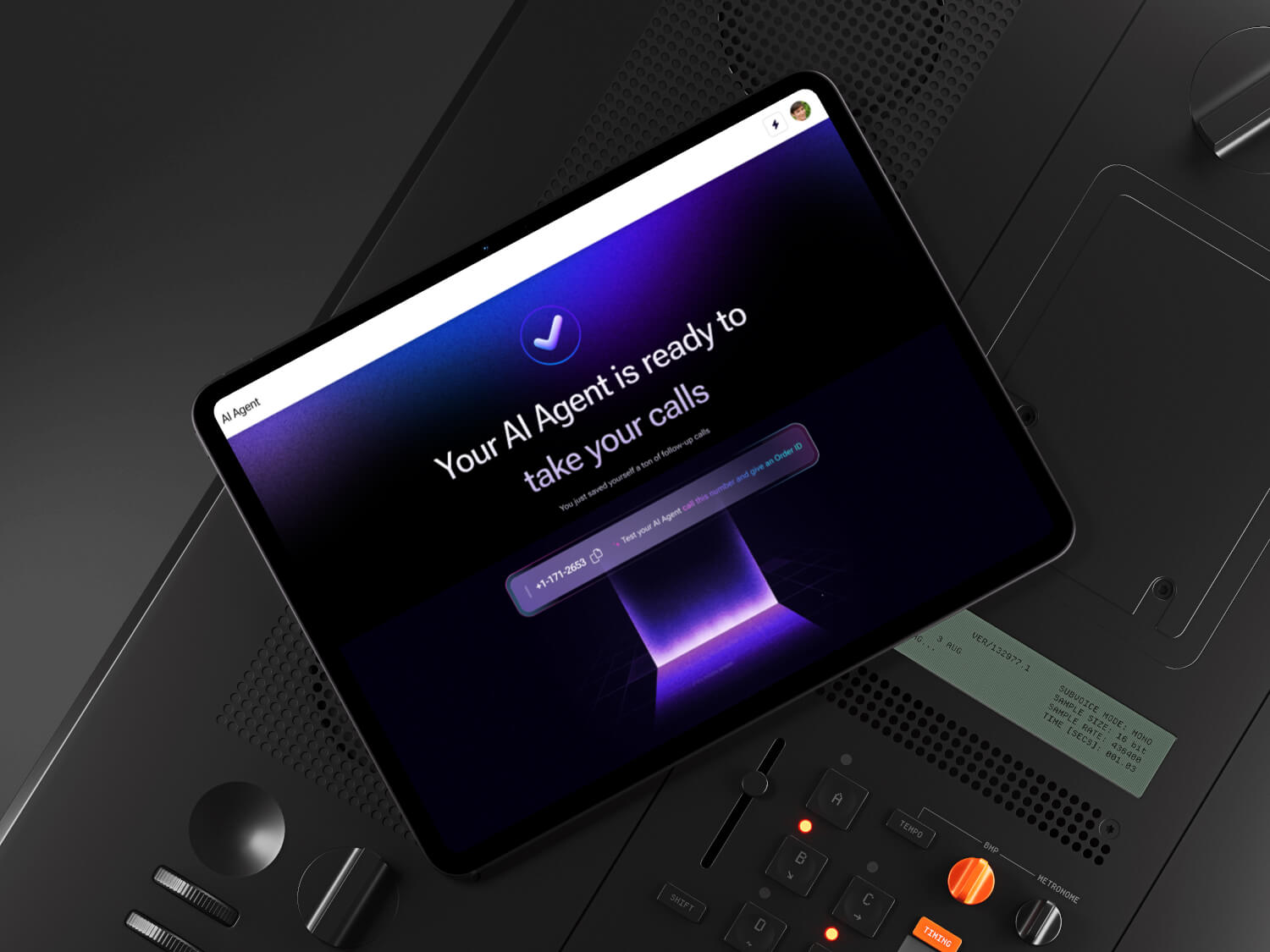 A sleek black tablet displaying a message, "Your AI Agent is ready to take your calls," is propped up on a sophisticated dark control panel with various buttons and switches, emphasizing modern technology and communication.