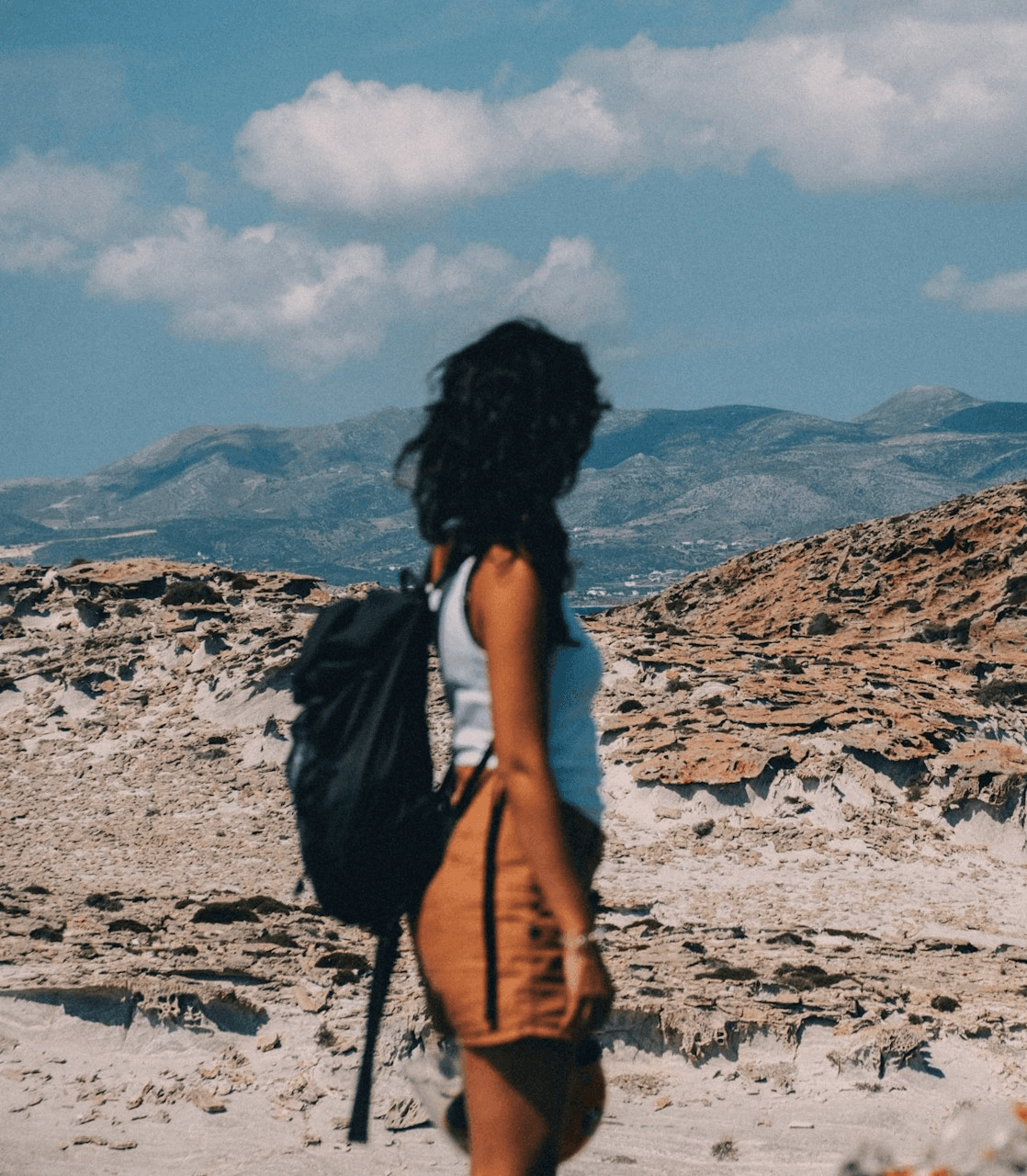 woman standing on brown sand under blue sky during daytime