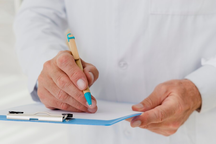 A doctor precribing medicines to the patients.