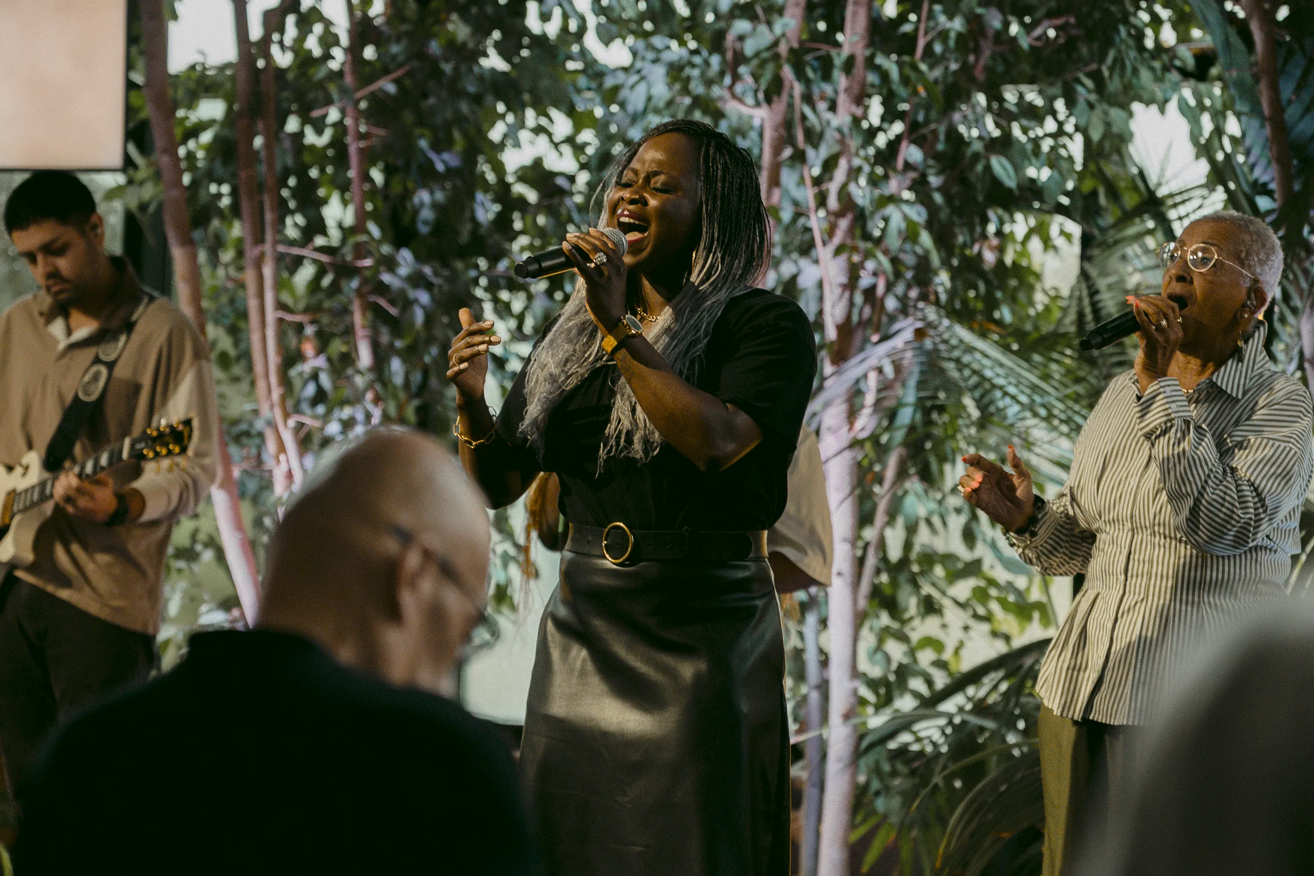 Worship team leading passionate Spirit-filled worship surrounded by trees during a Sunday service at Elan Church in Naperville, IL