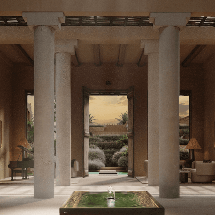 An open courtyard at the entrance of a building, overlooking a garden