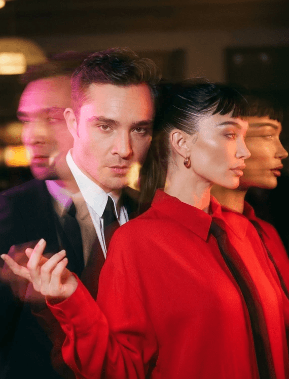 Woman in black outfit posing with arms raised