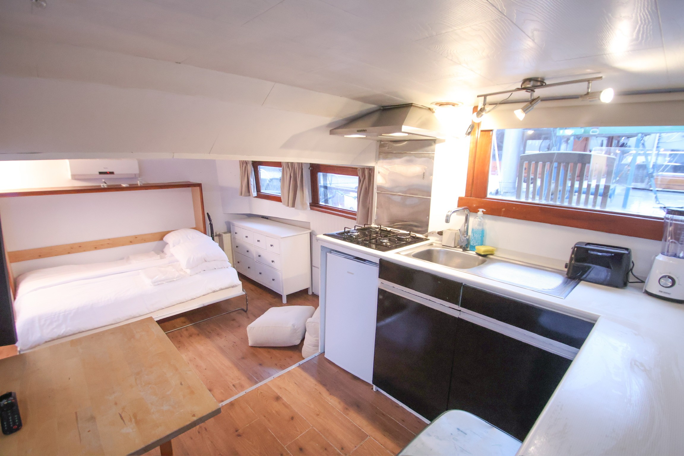 Gray sectional sofa with black coffee table and blue rug