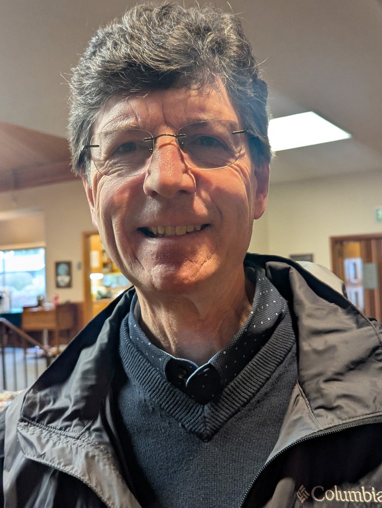 woman in gray coat singing on stage