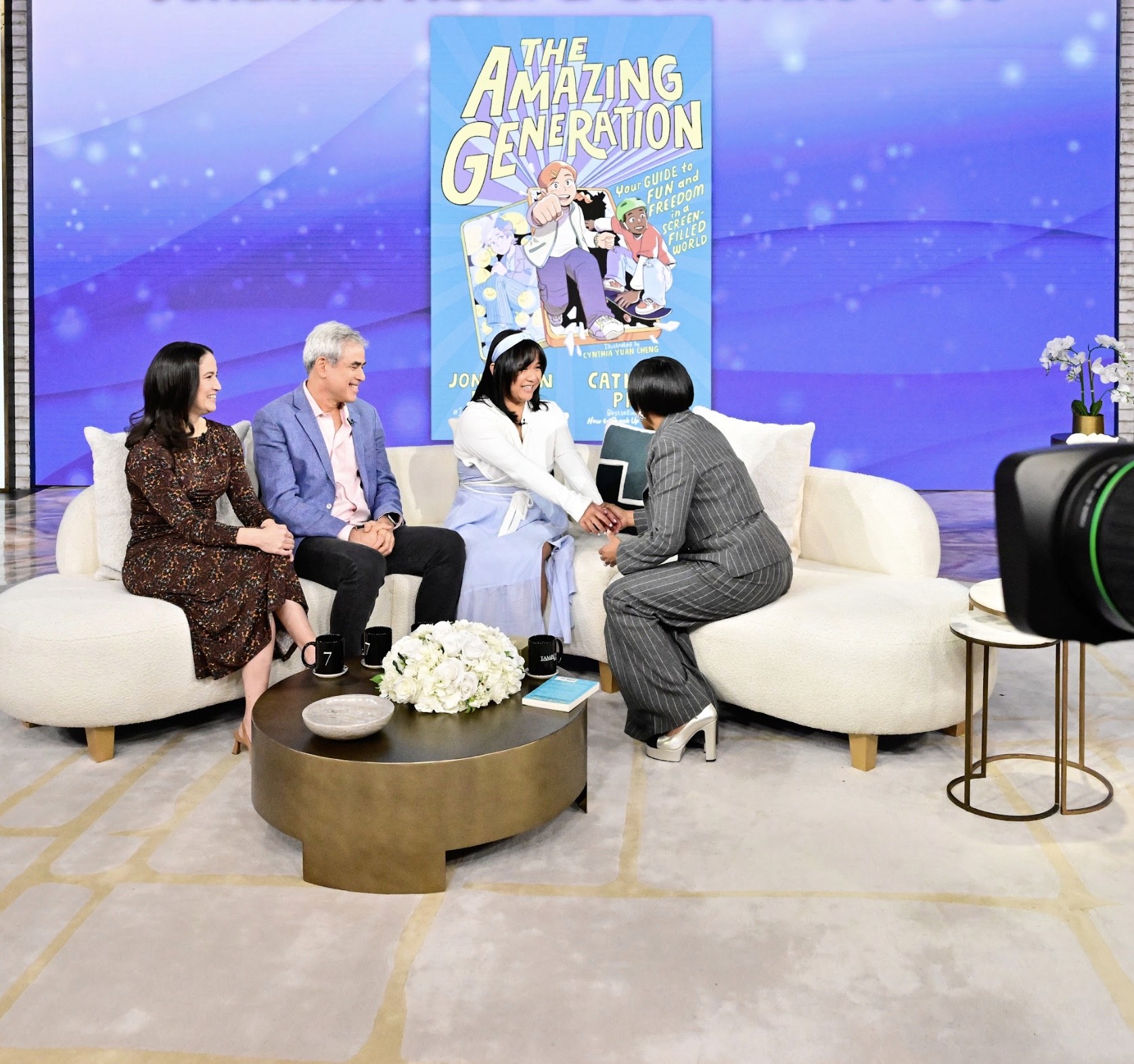 Four people sitting on a couch and smiling