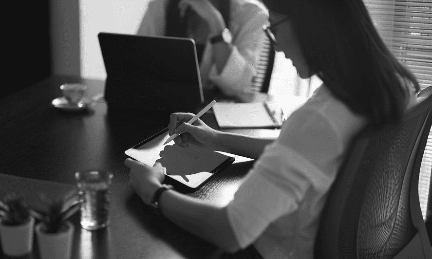 A creative professional working on a digital tablet
