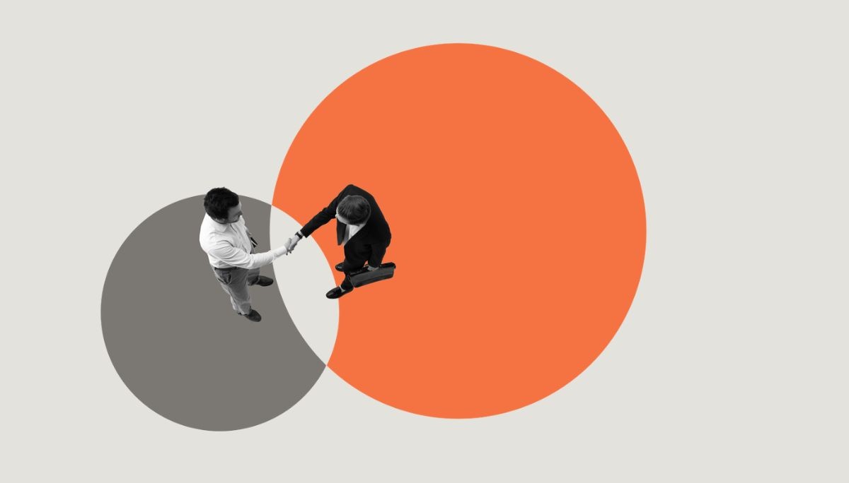 Top view of two professionals shaking hands, symbolizing how to quit a job professionally without burning bridges.