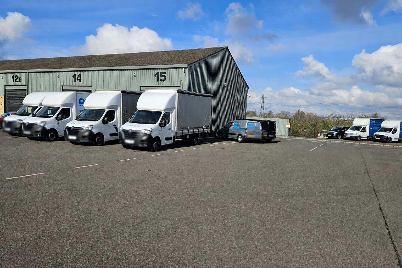 Man & woman stand in front of a few boxes