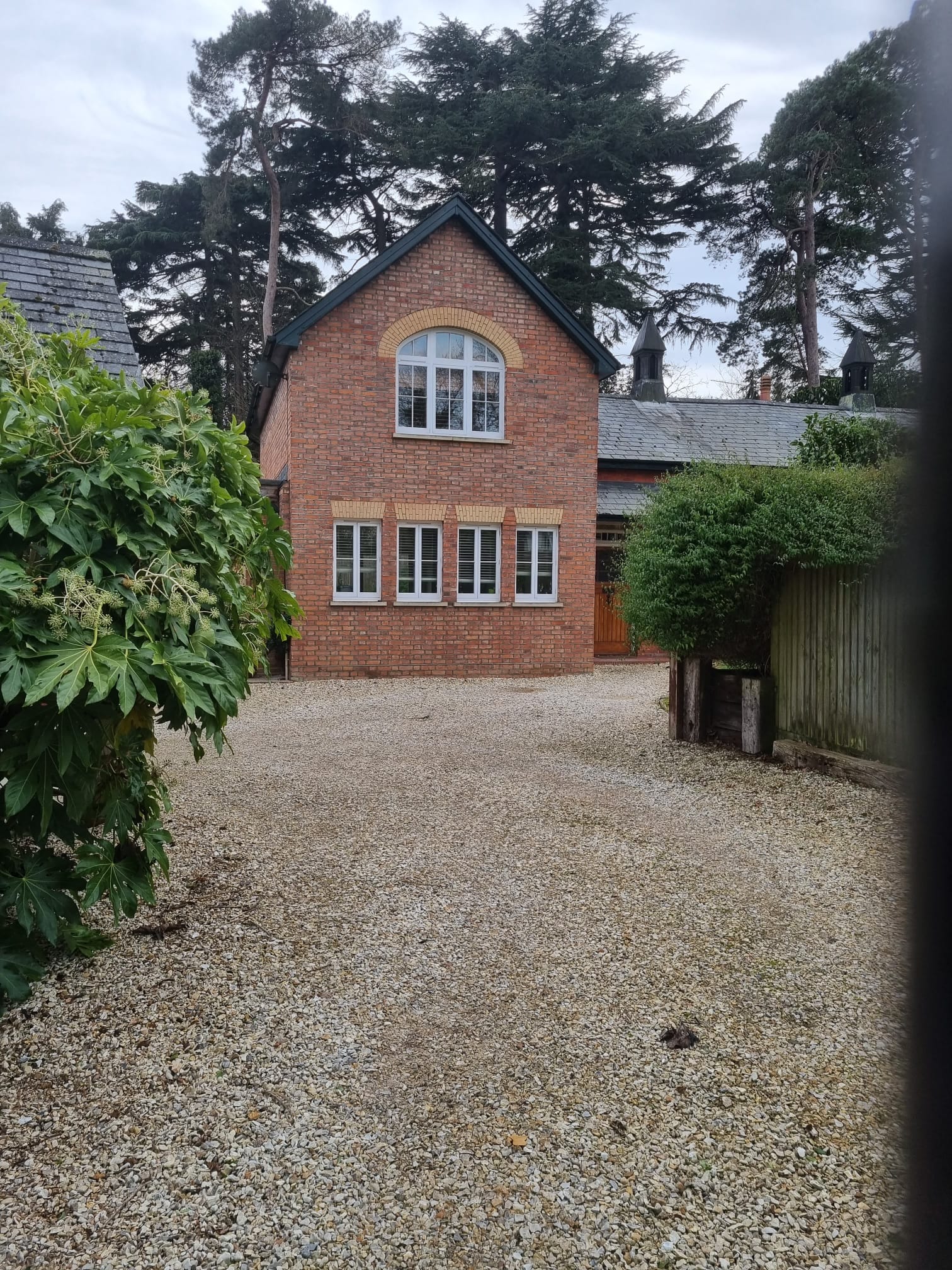 a rendering of a house with a brick driveway