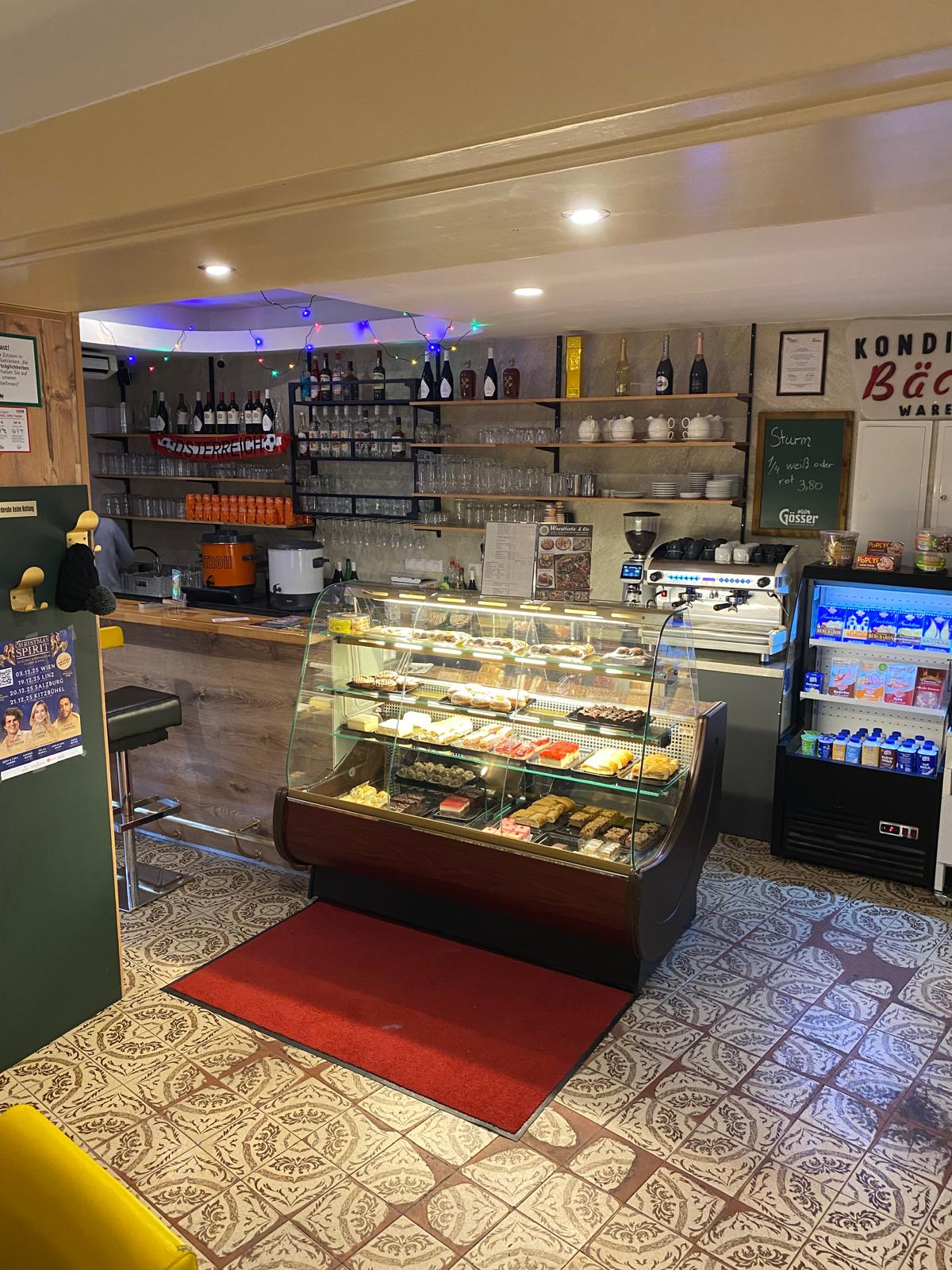 Plate with a seared salmon fillet topped with green herb garnish and sauce, served on a white dish placed on a dark green marble table beside a white candlestick.