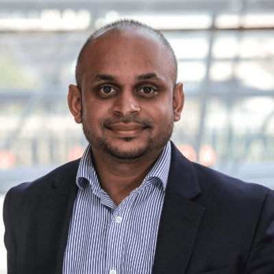 Black and white portrait of a smiling person with curly hair