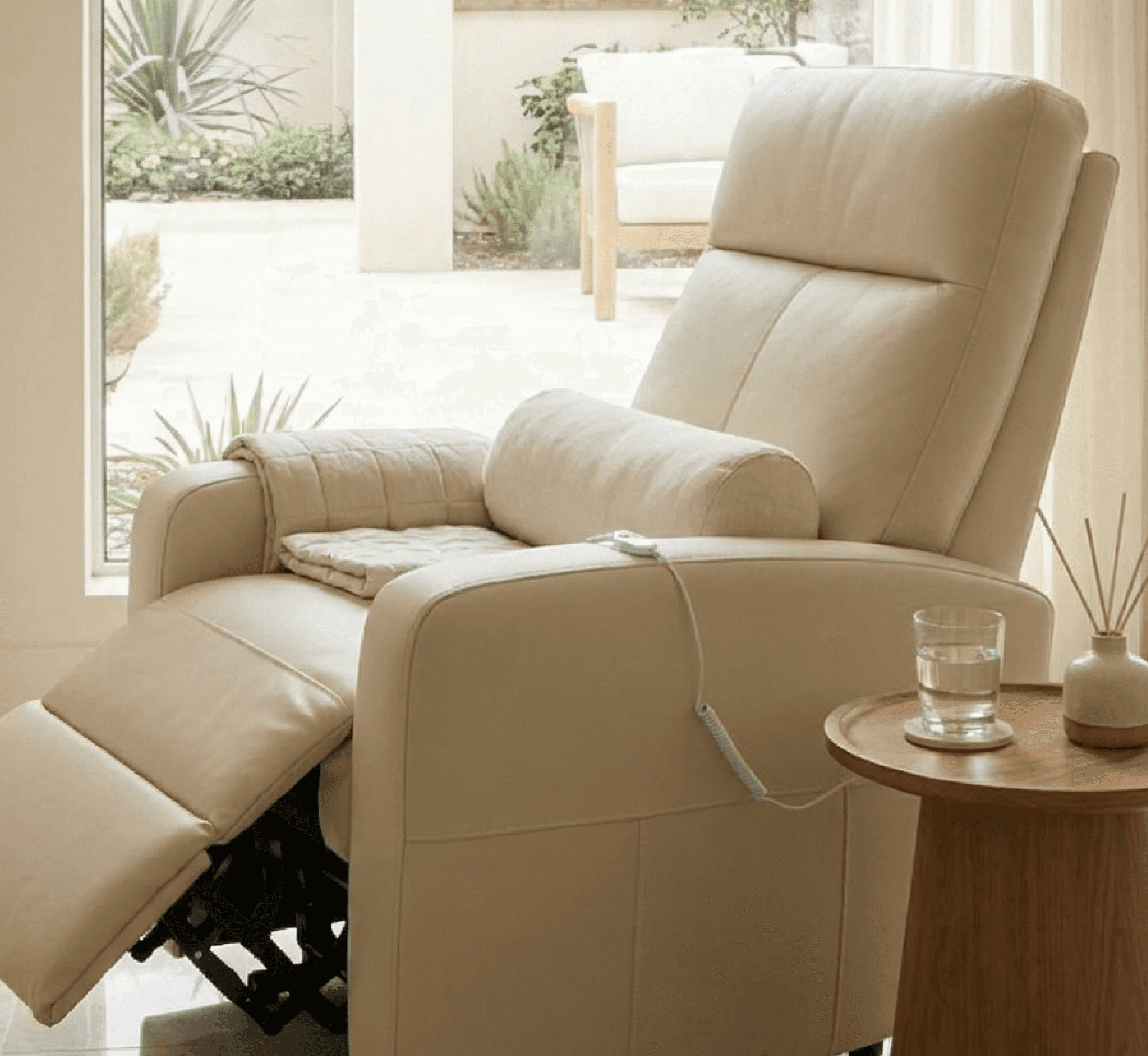 Cream electric medical recliner chair for patient treatment.
