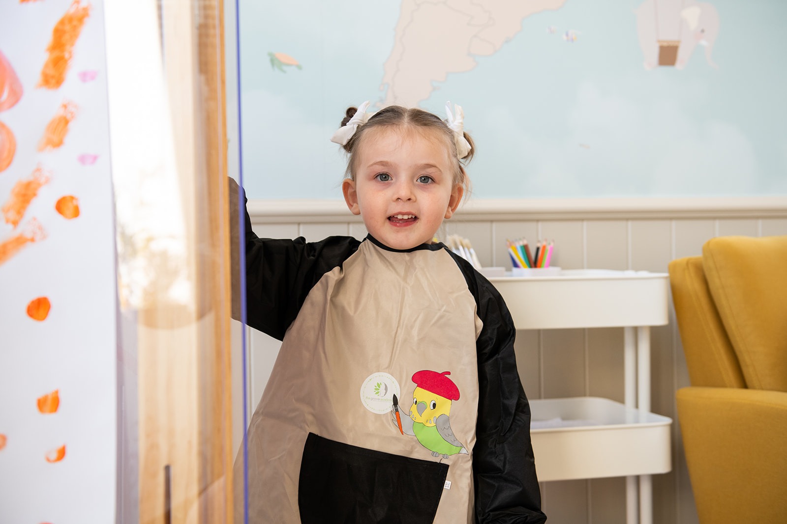 Close-up of a dark green leaf showing its textured surface and central vein against a muted background.