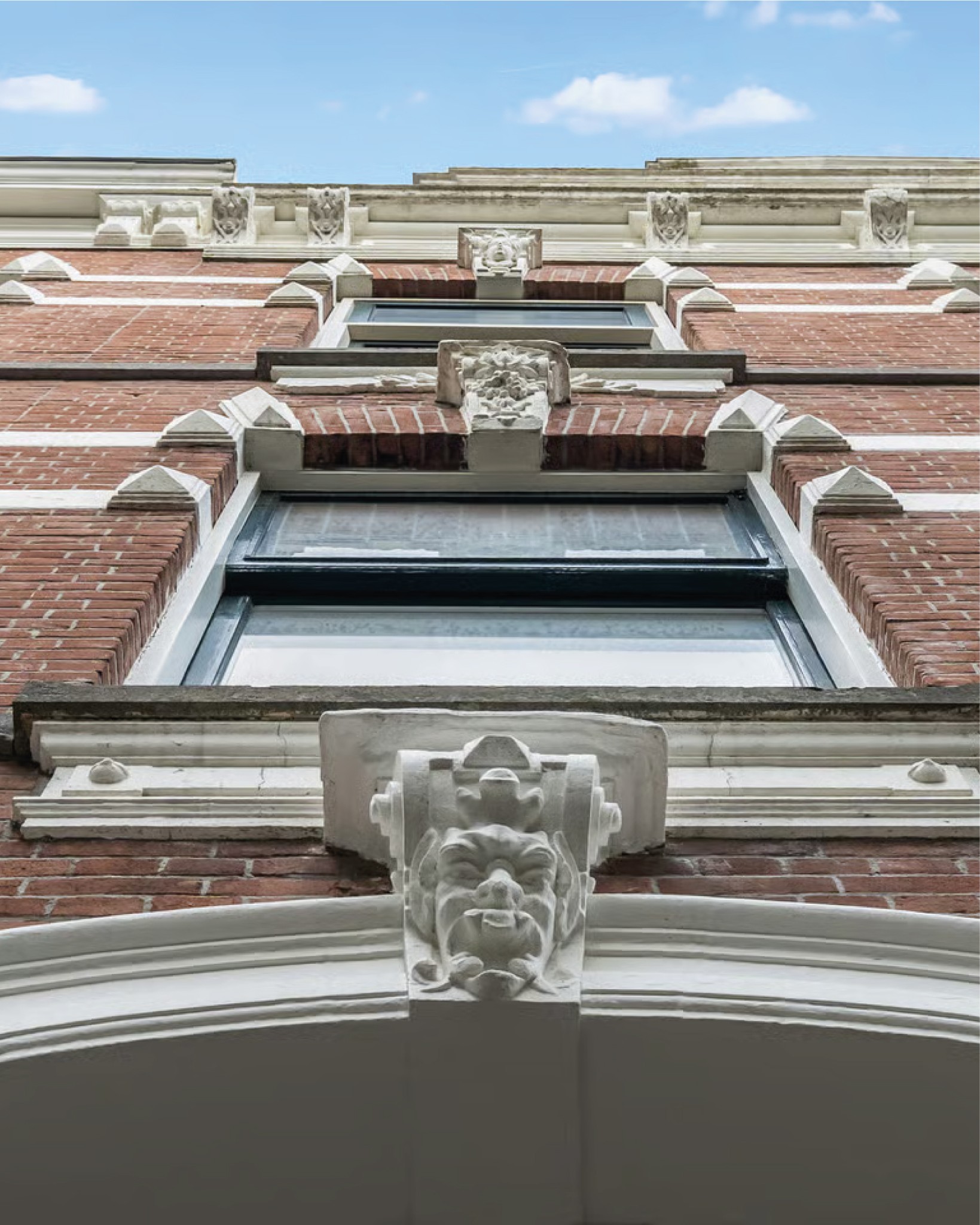 groot raam dat het interieur laat zien van the grayhouse van bespoke design studio, baksteen en zwart zink