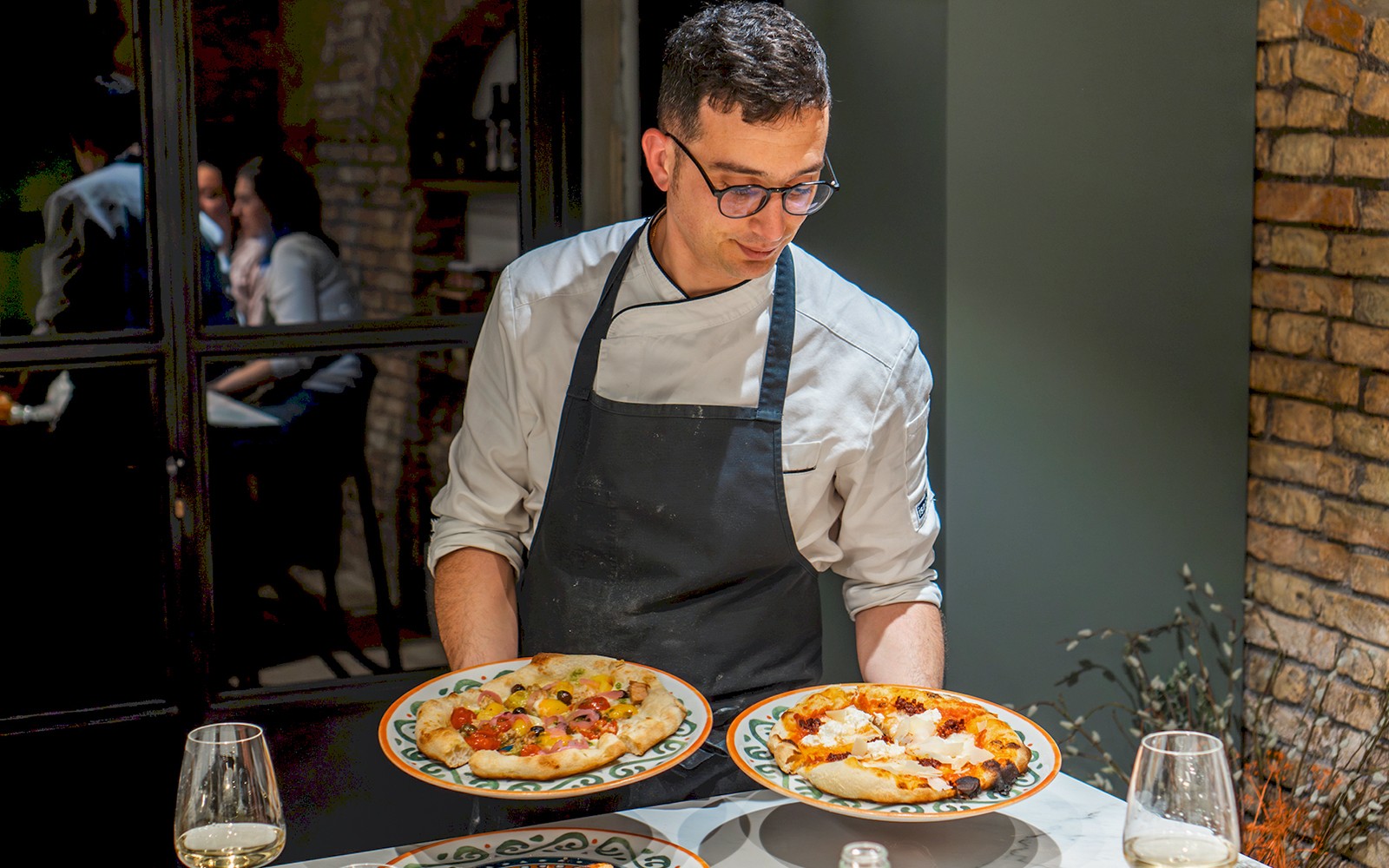 People learning to make traditional Italian pizza in a cooking class in Rome.