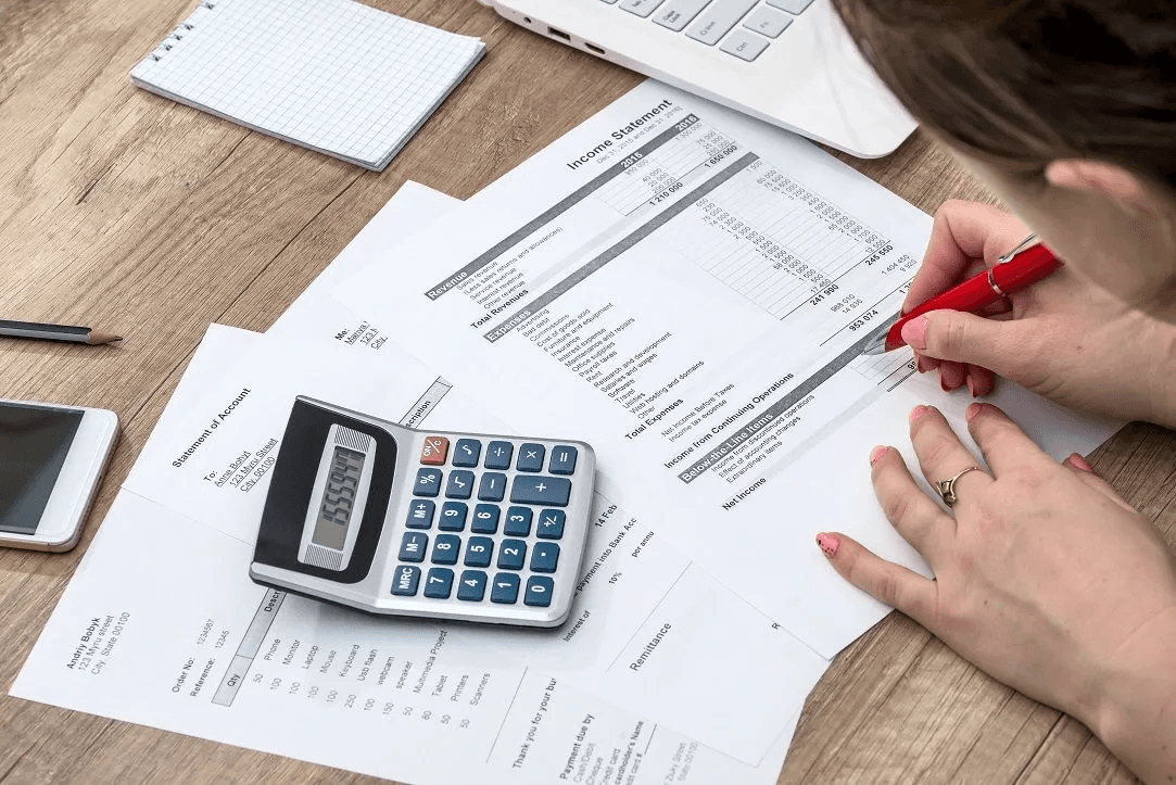 Person analyzing documents - How to Categorize Small Business Expenses