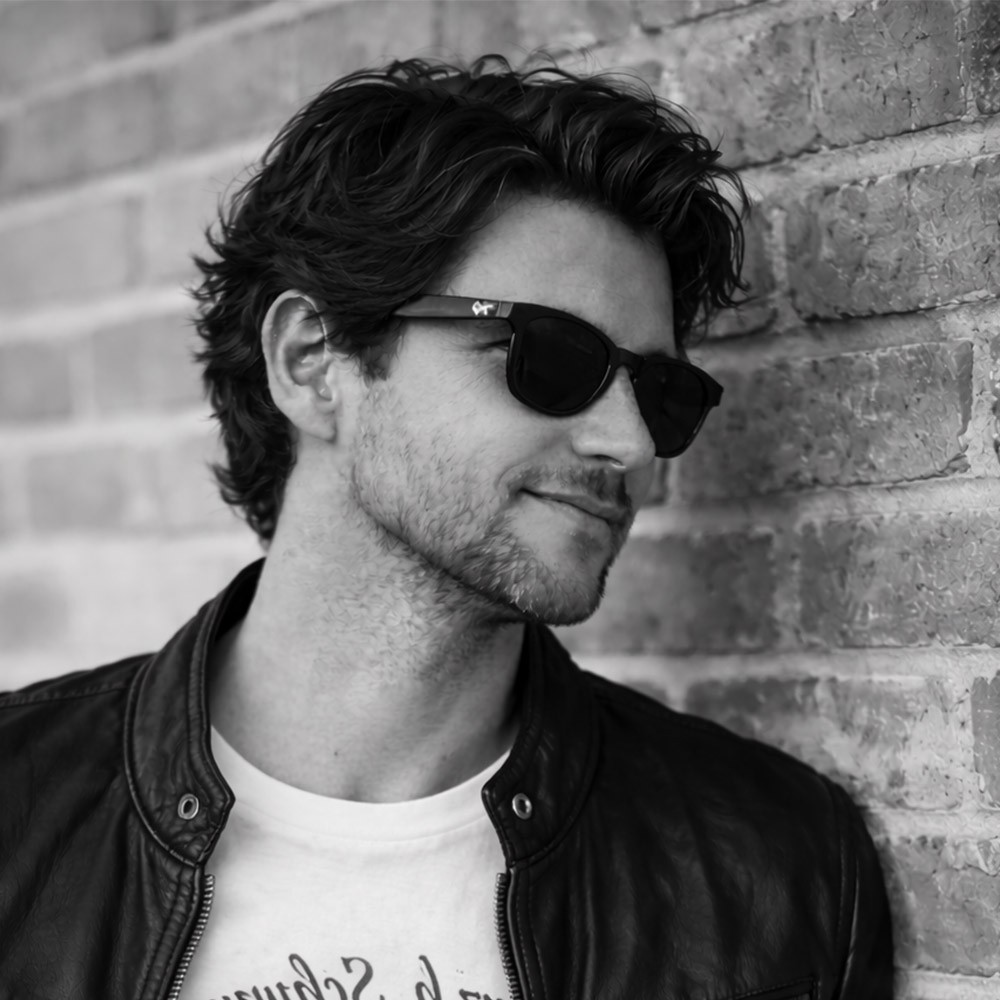 Male with glasses looking at the camera