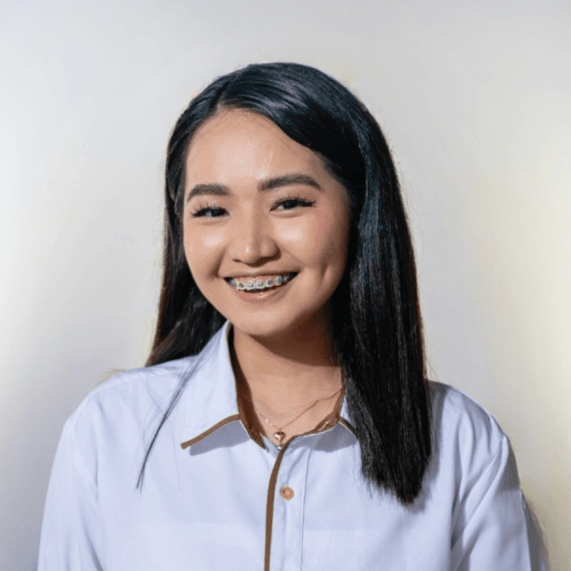 Portrait of a person in dark clothing speaking on a phone