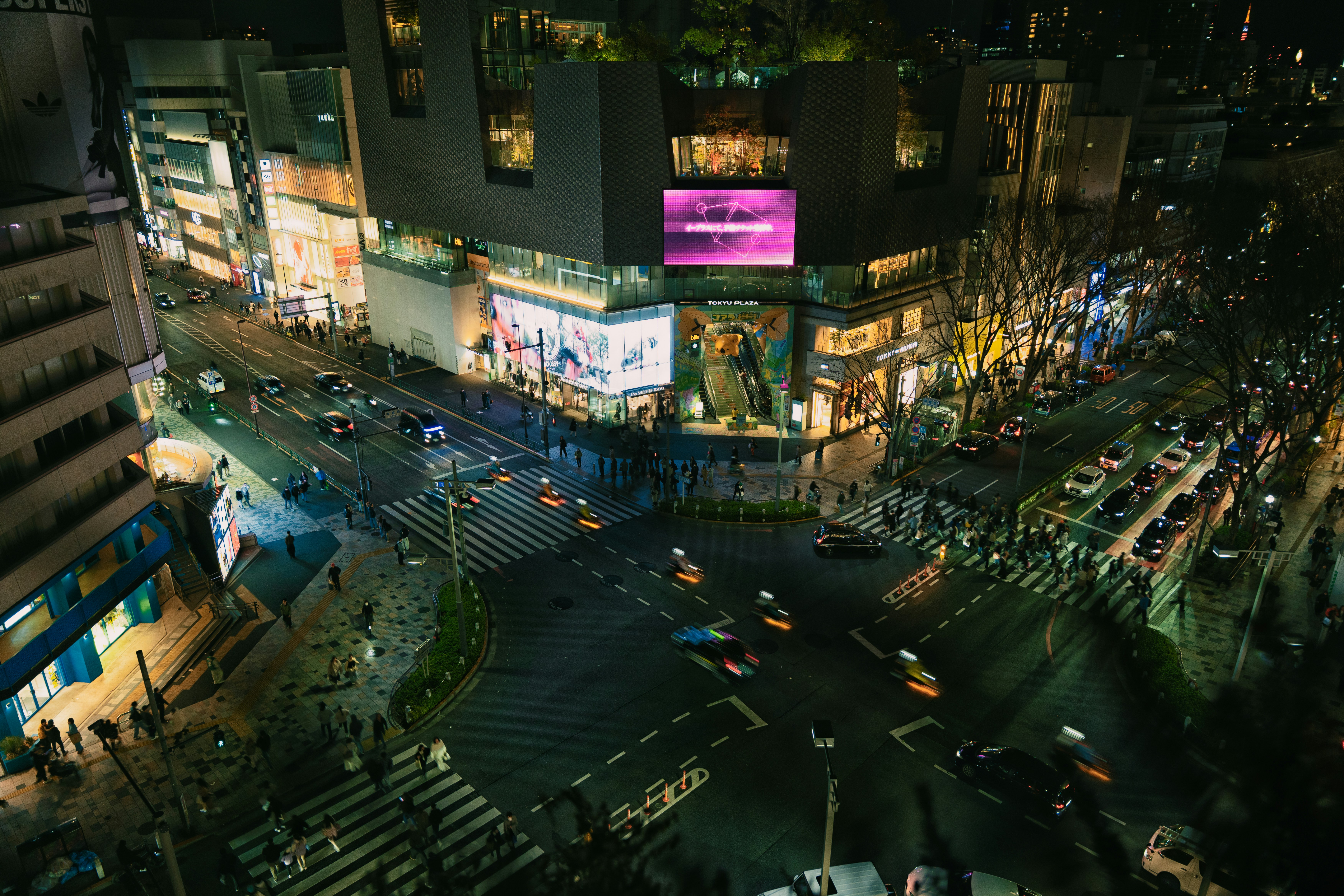 Busy city intersection at night with traffic and lights