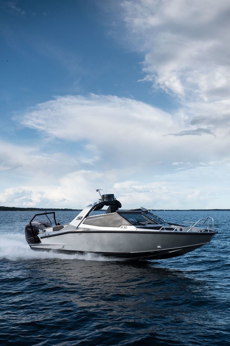 man in black and white jacket and black pants riding white and black skateboard during daytime