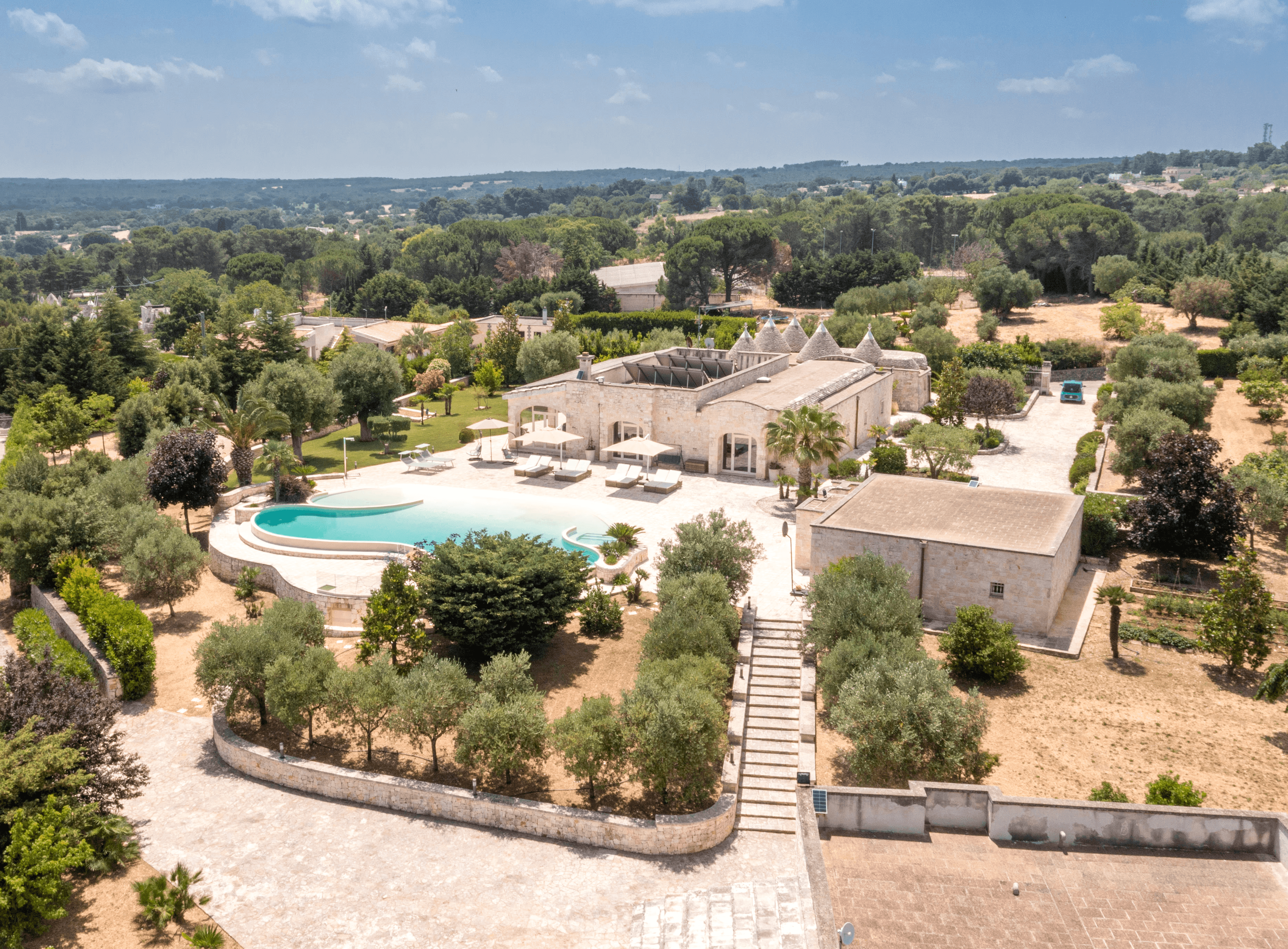 Modern house with elevated glass balcony and hillside view